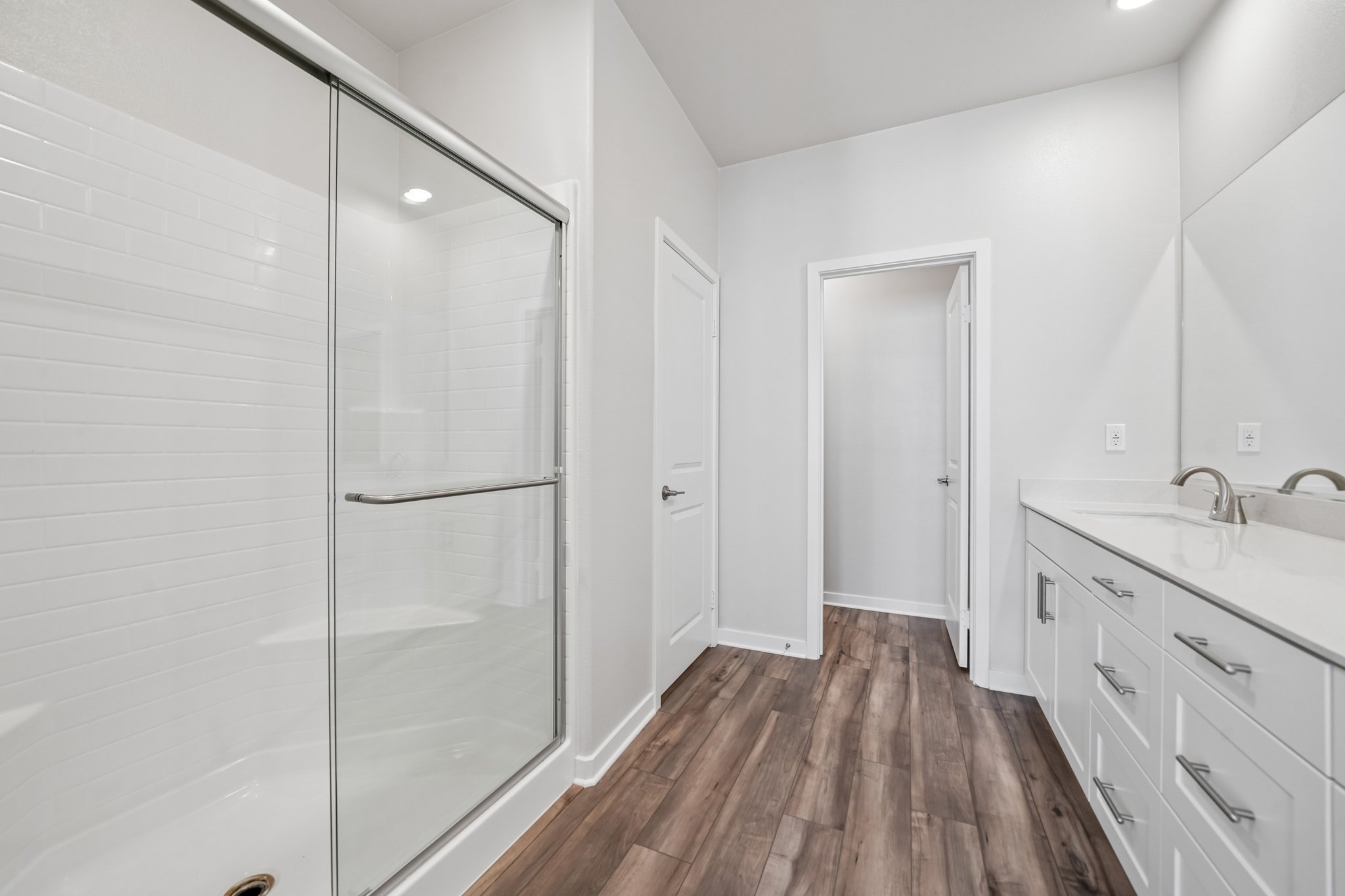 A bathroom with white cabinets.