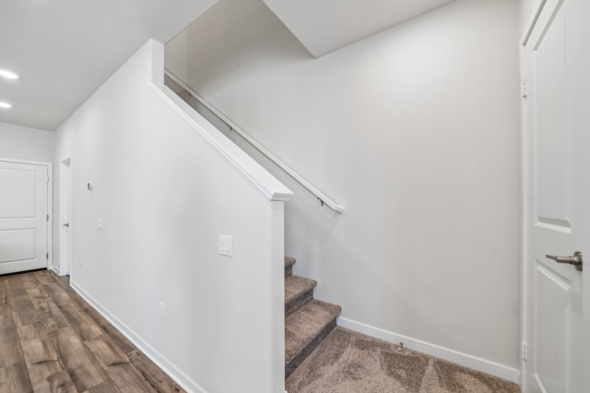 A white wall with a door.