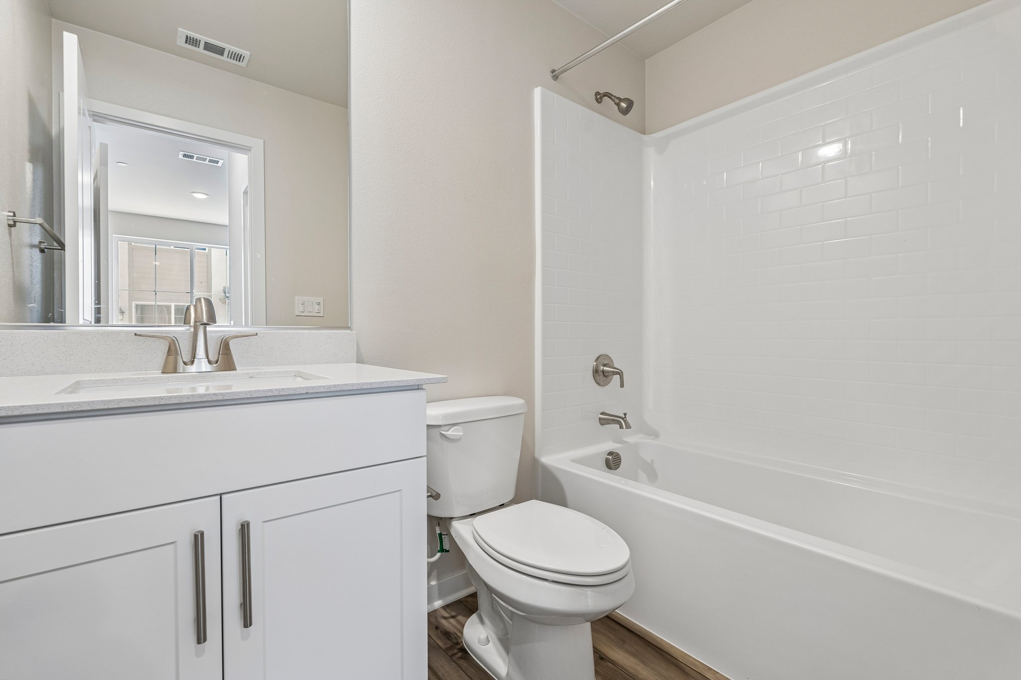 A bathroom with a tub toilet and sink.