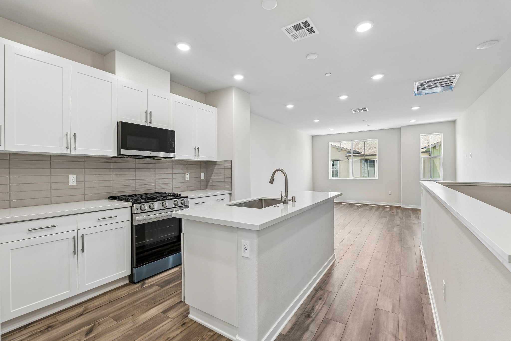 A kitchen with white cabinets.