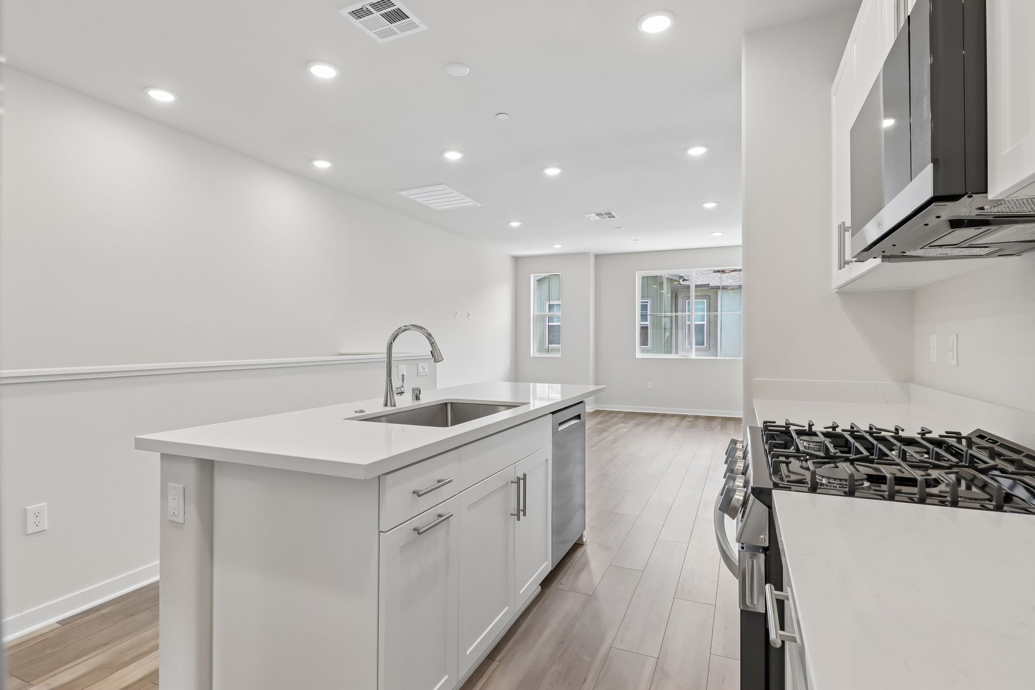A kitchen with white cabinets.