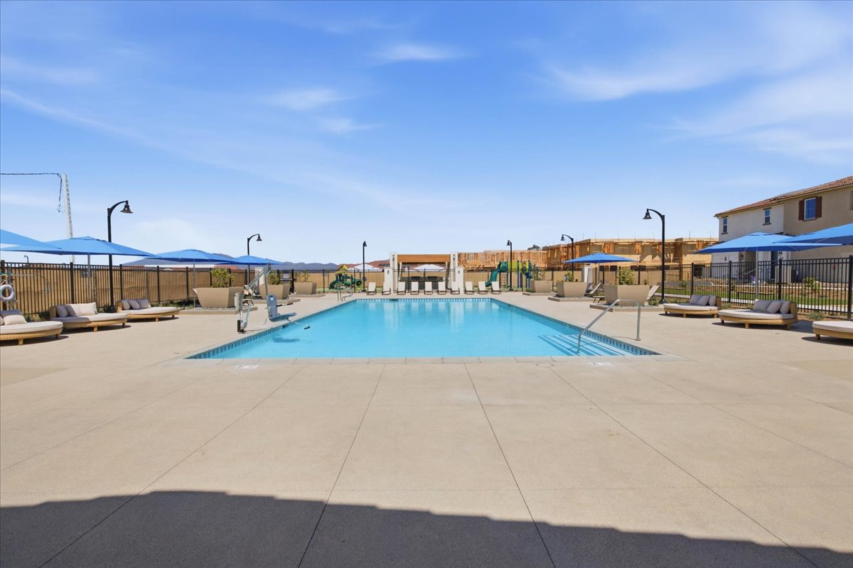 A swimming pool in a sandy area.