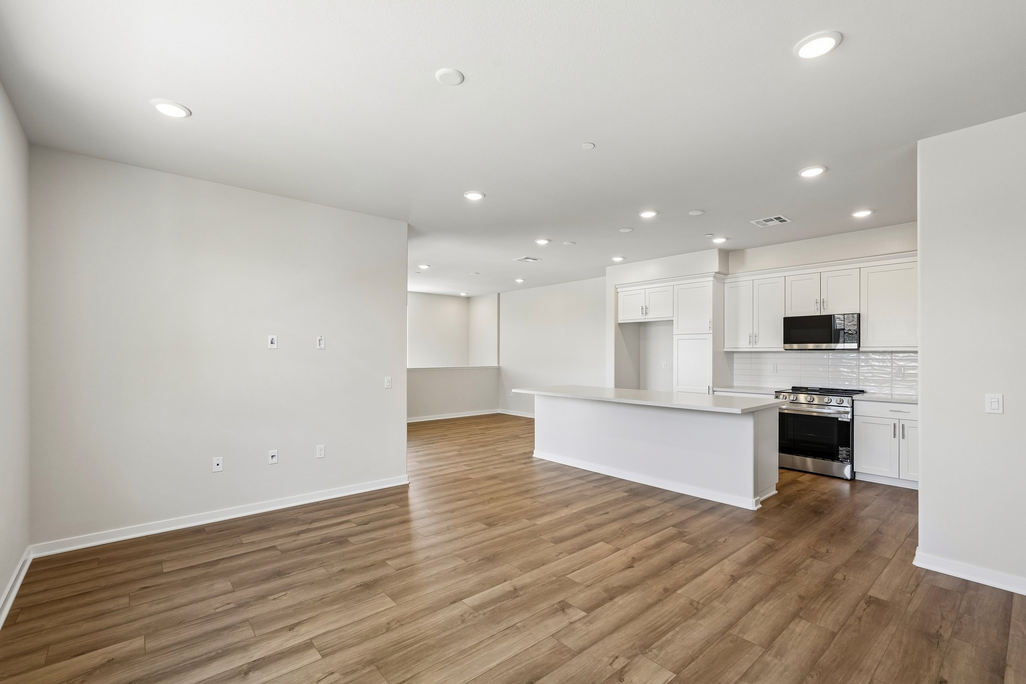 A large kitchen with white cabinets.