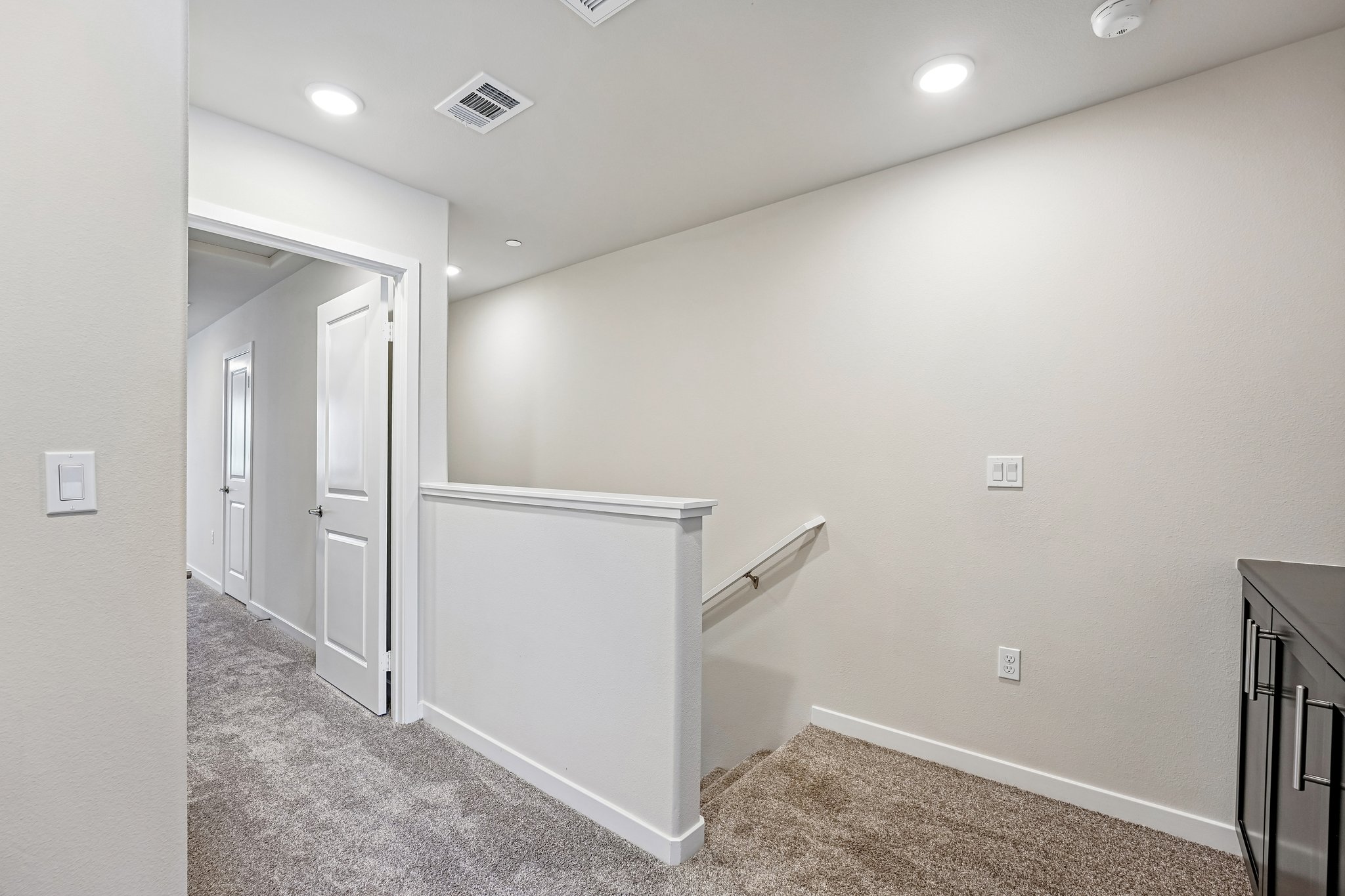 A room with a white wall and a white cabinet.