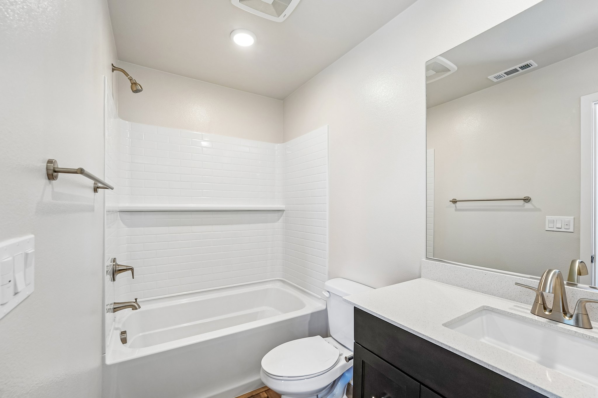 A bathroom with a tub sink and toilet.