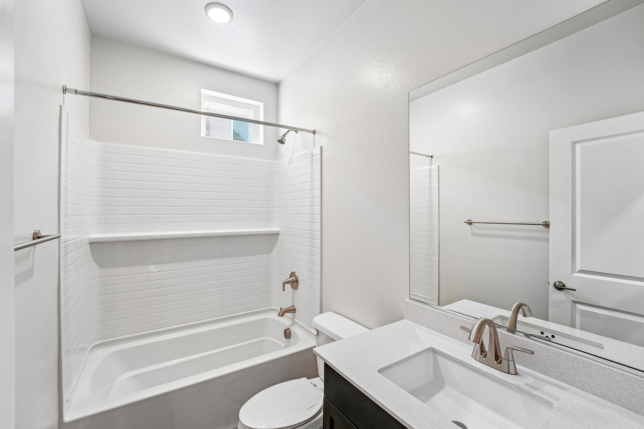 A bathroom with a tub sink and toilet.