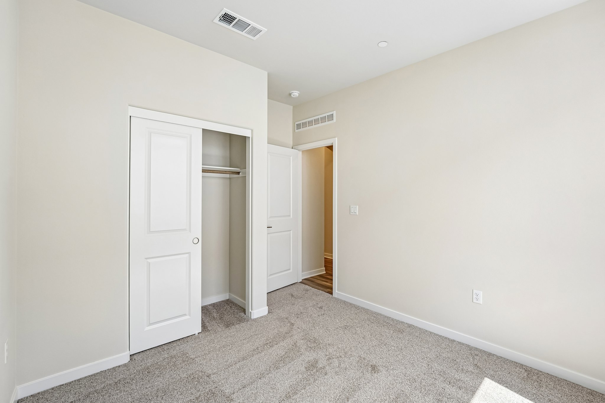 A hallway with white doors.