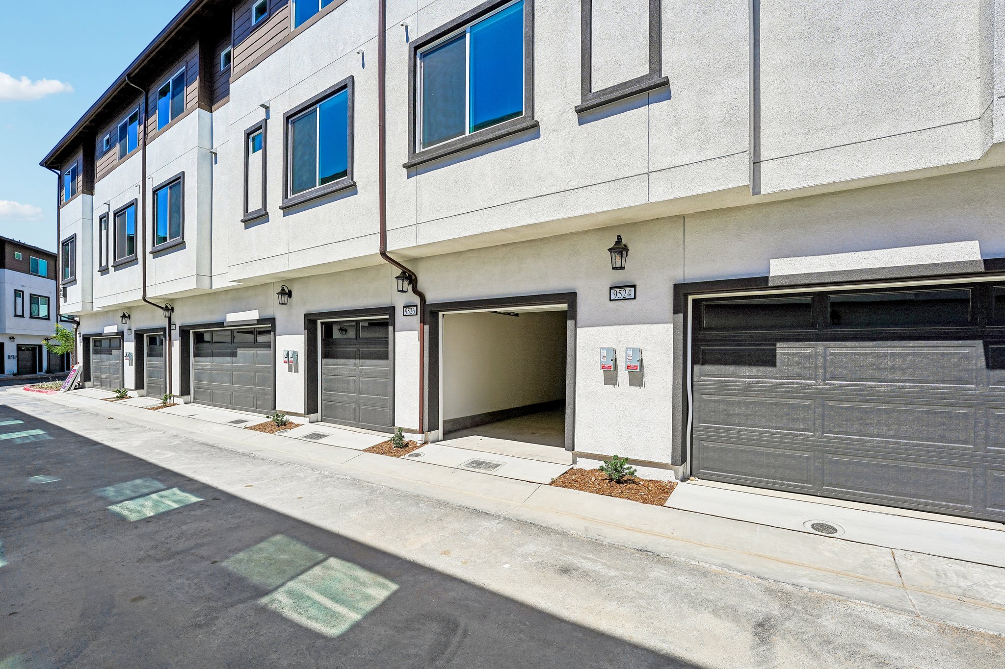 A building with garages and a sidewalk.