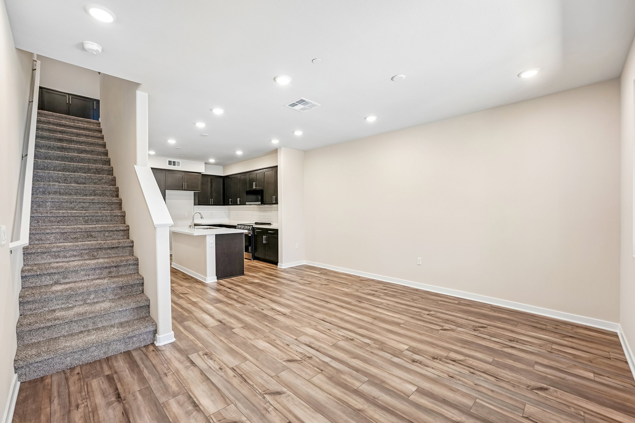 A large kitchen with wood floors.