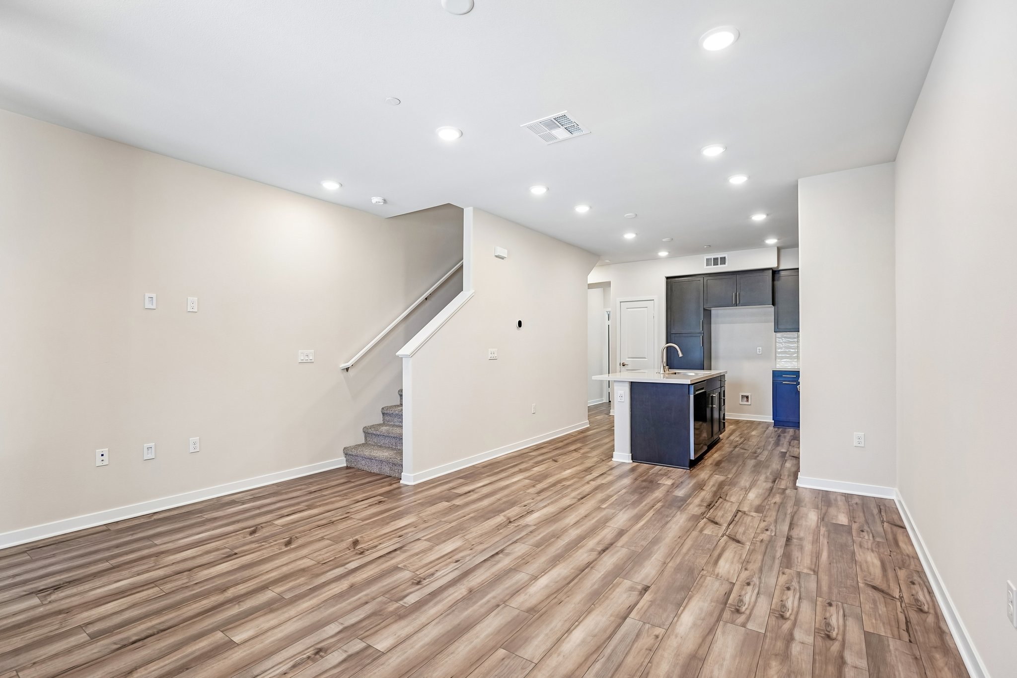 A room with a wood floor and white walls.