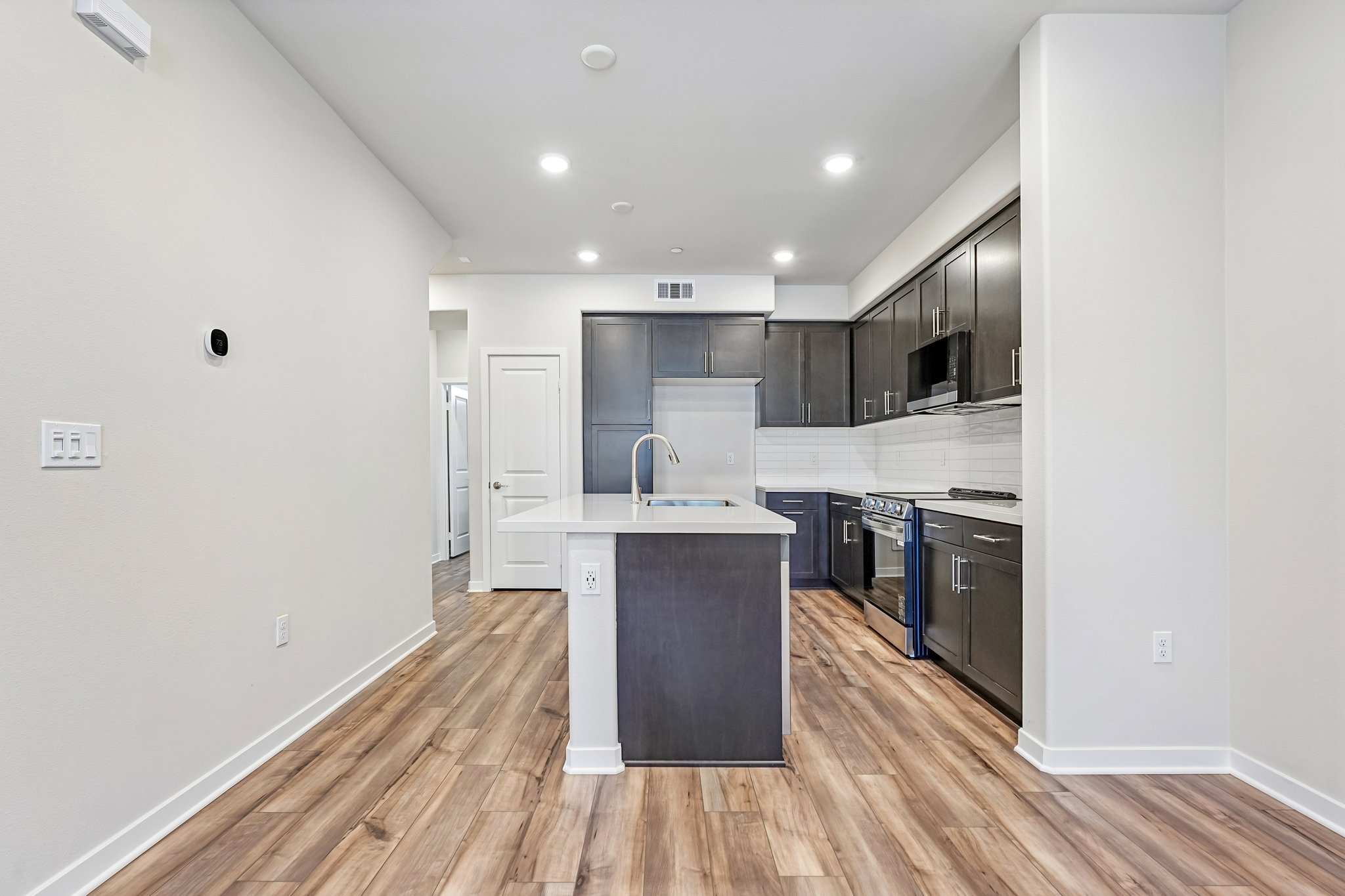 A kitchen with white cabinets.