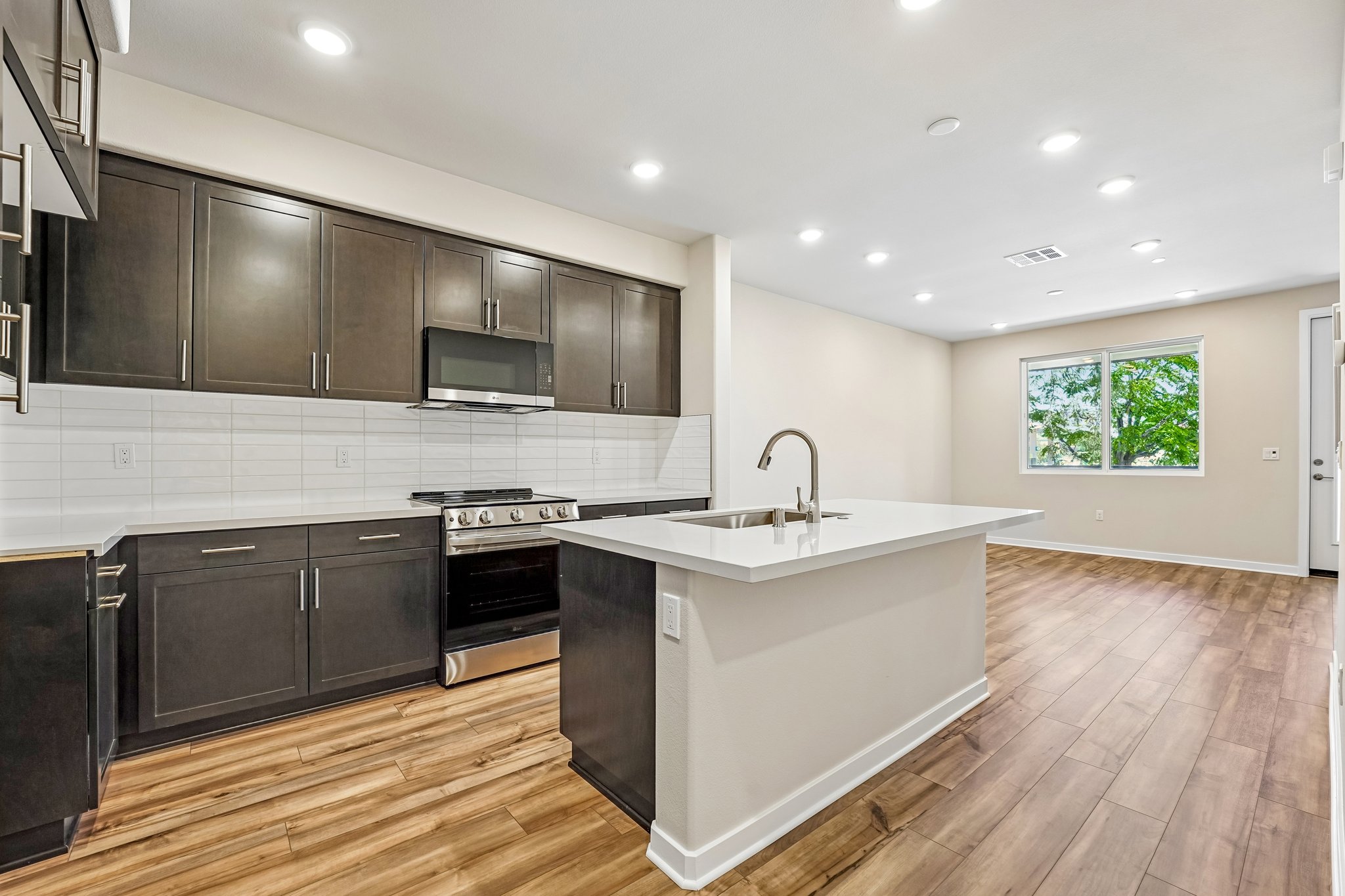 A kitchen with black cabinets.