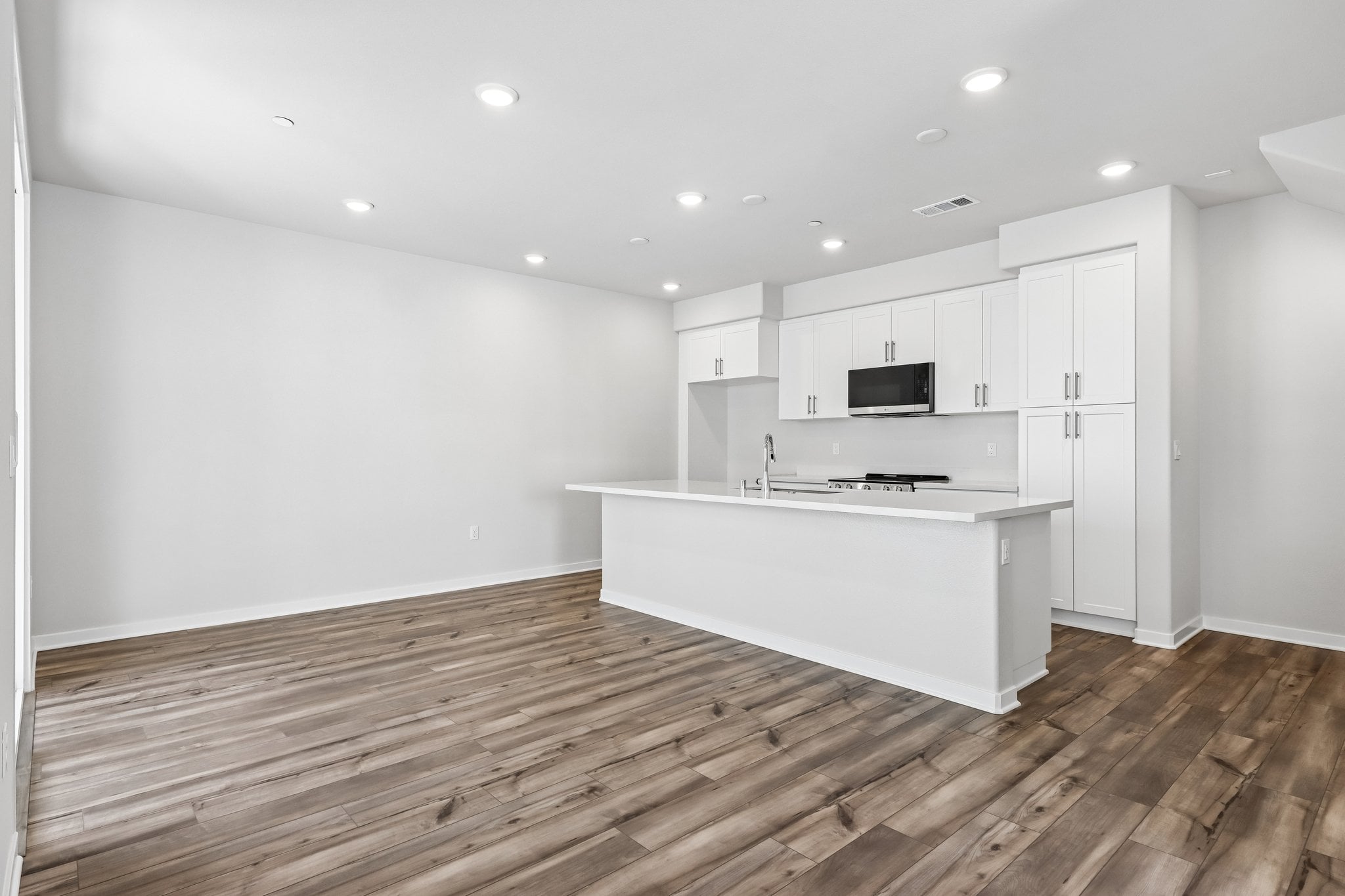 A kitchen with white cabinets.