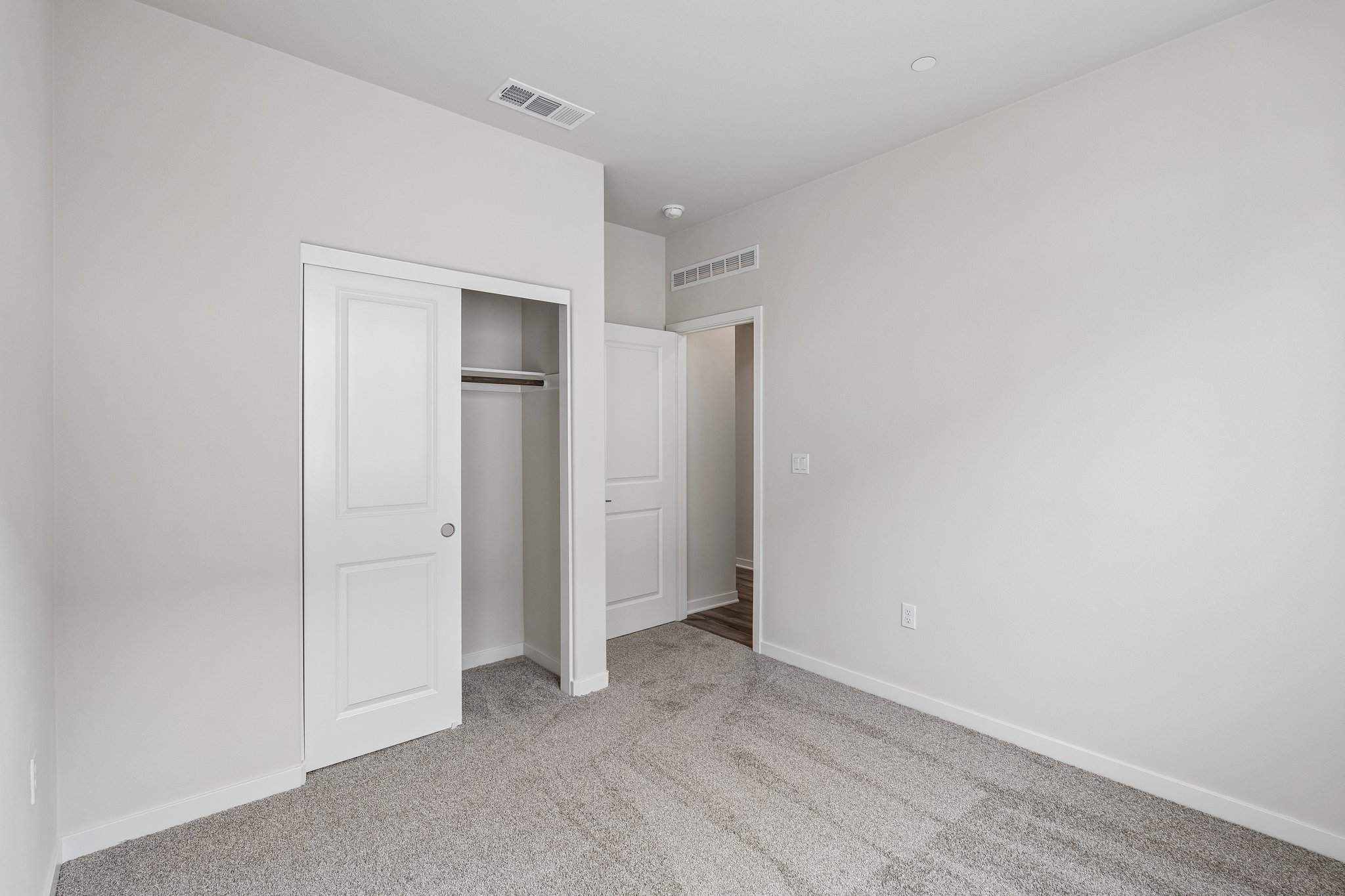 A hallway with white doors.