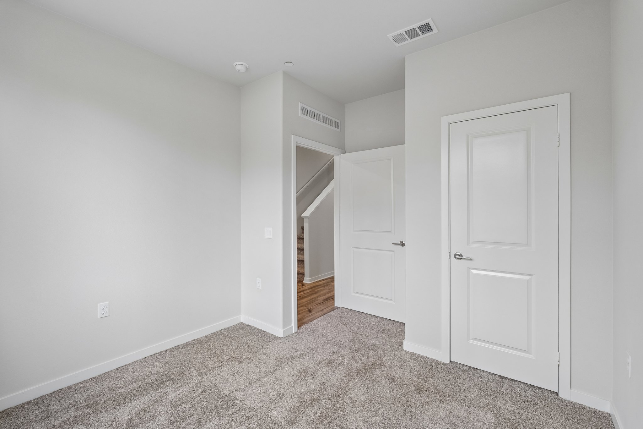 A hallway with white doors.