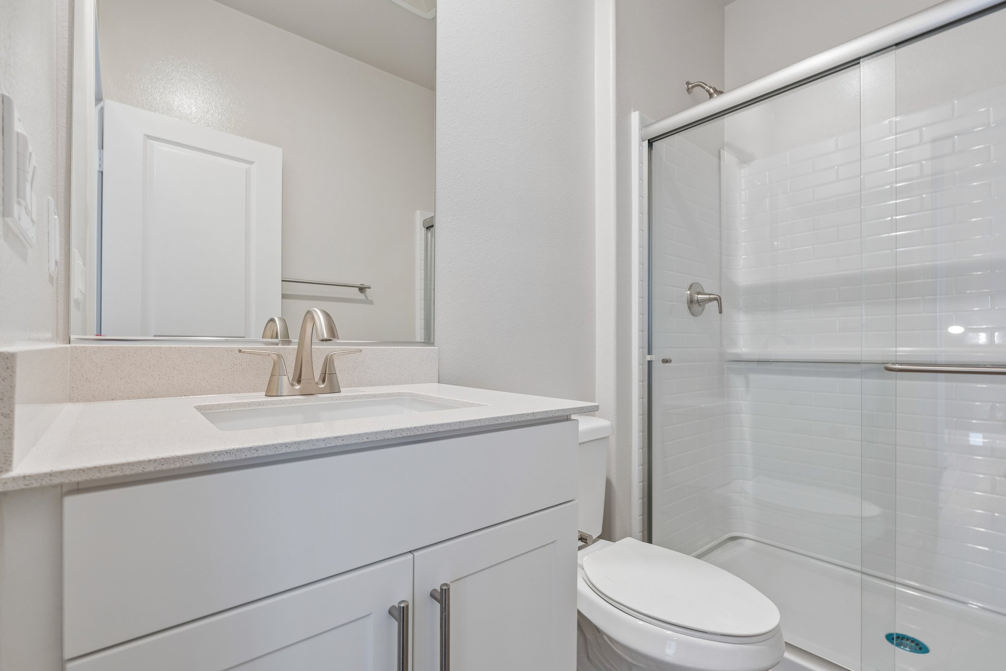 A bathroom with a glass shower.