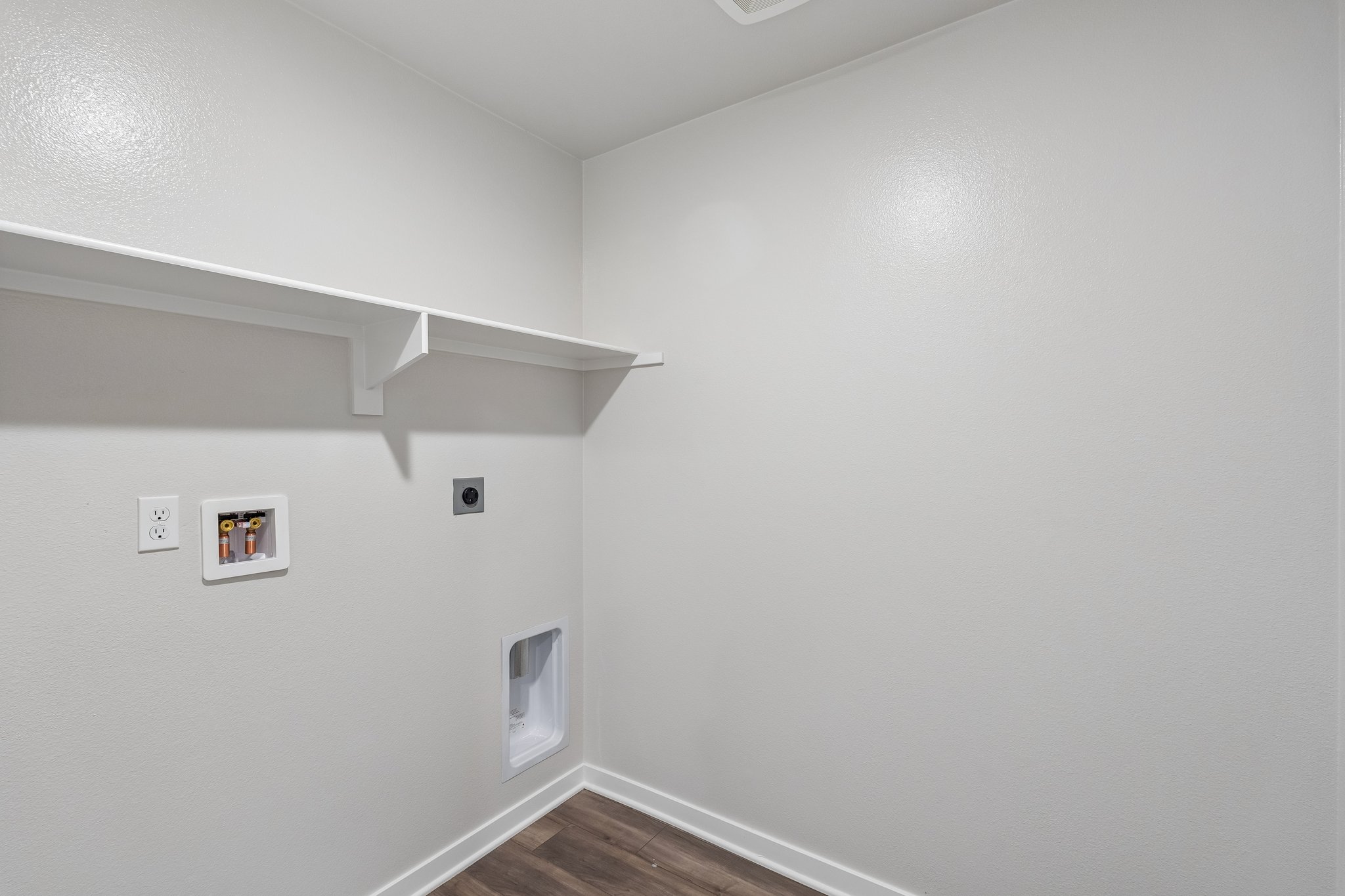 A white wall with a picture on it.