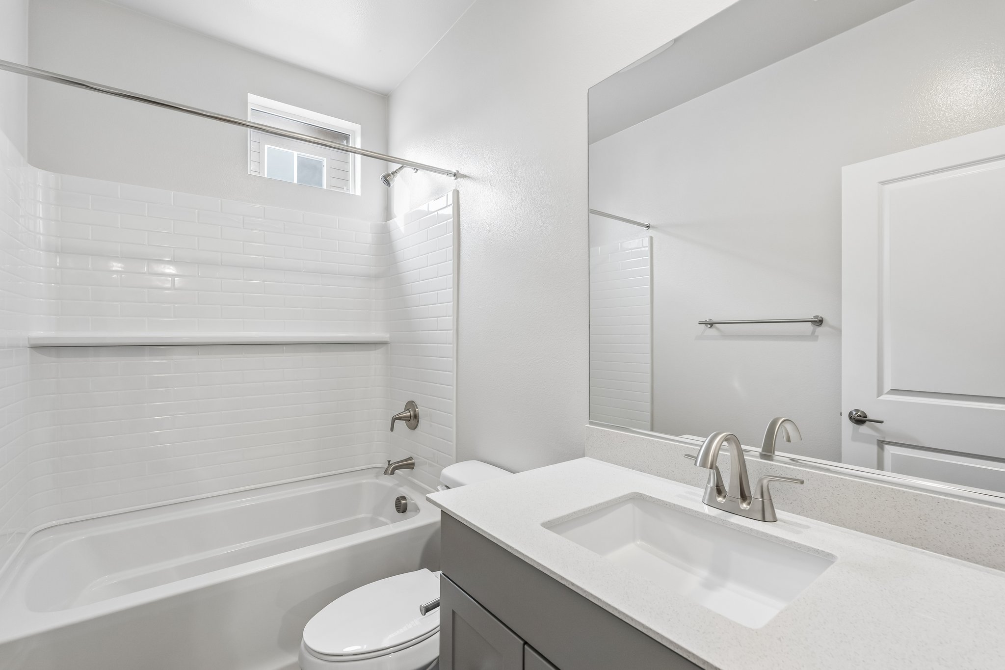 A bathroom with a tub sink and toilet.