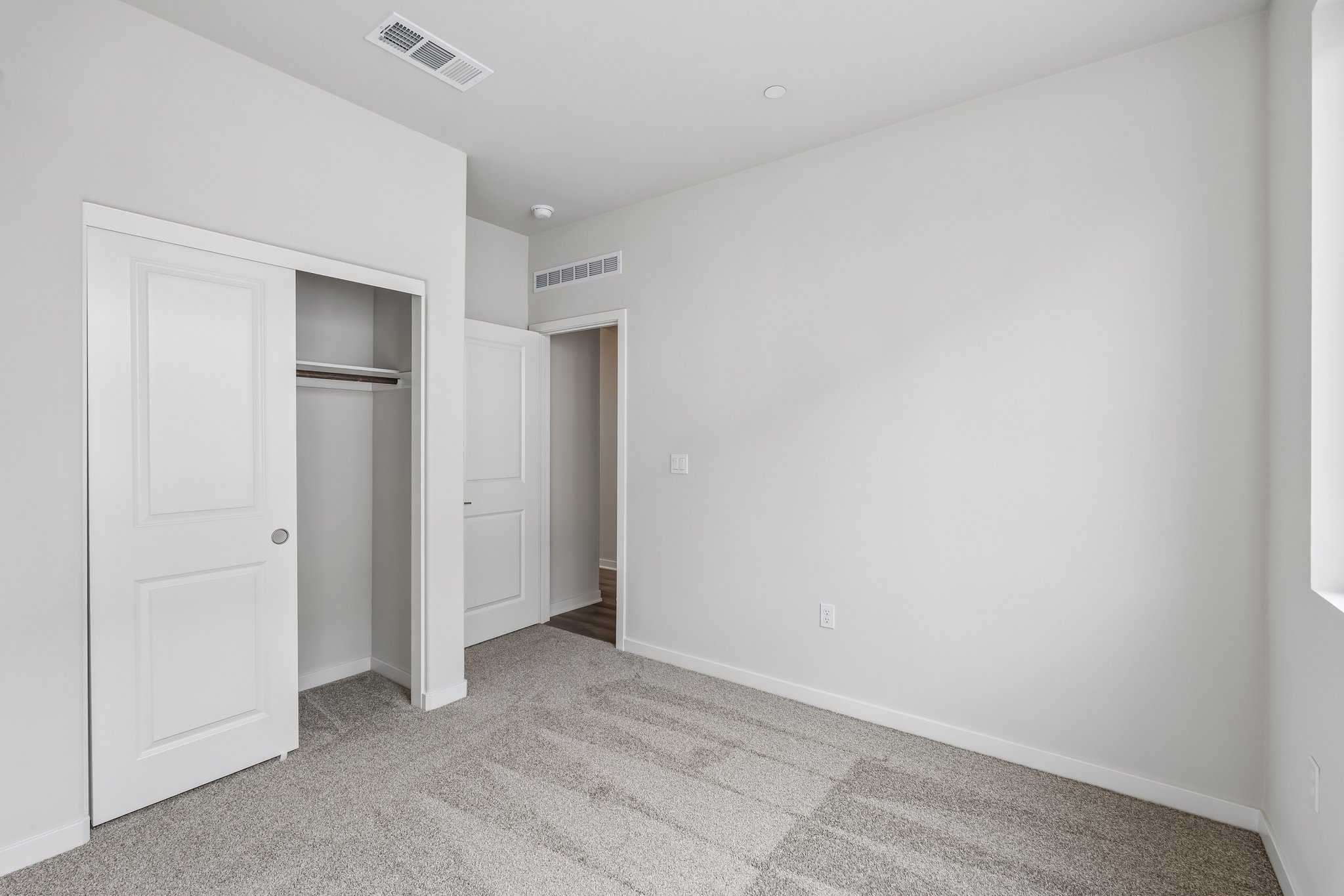 A hallway with white doors.