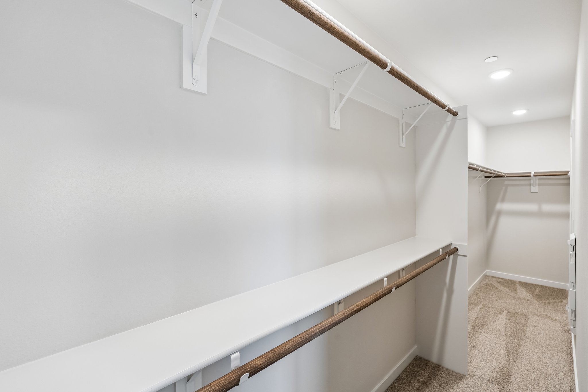 A white bathroom with a shower unit.
