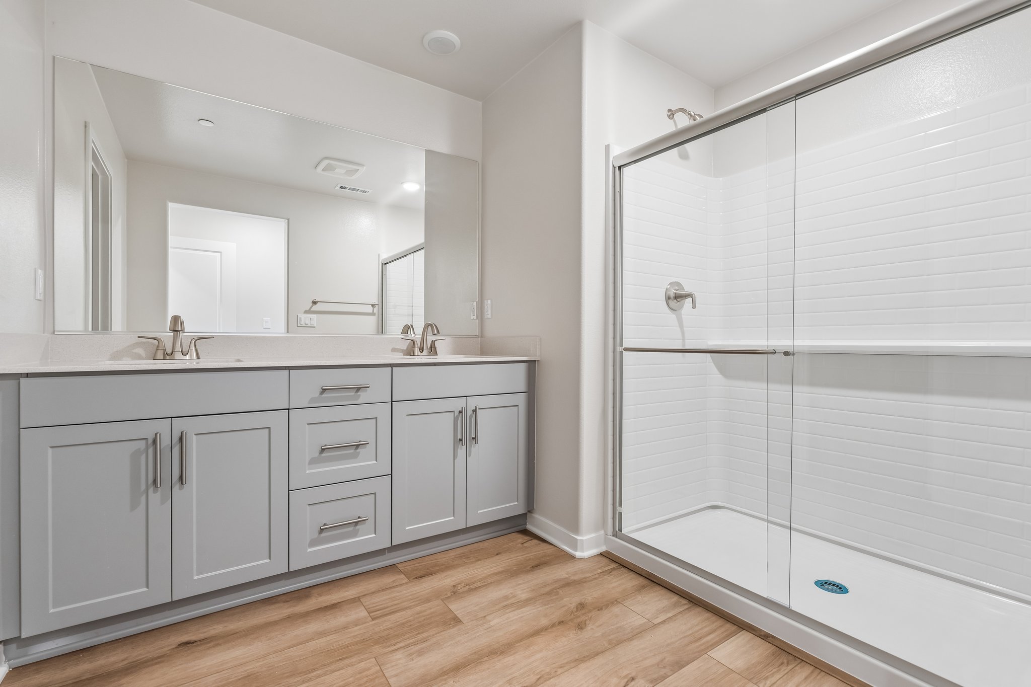 A bathroom with white cabinets.