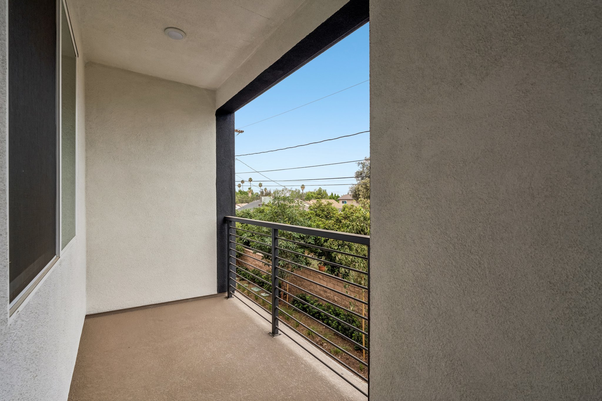 A view of a gate from a window of a building.