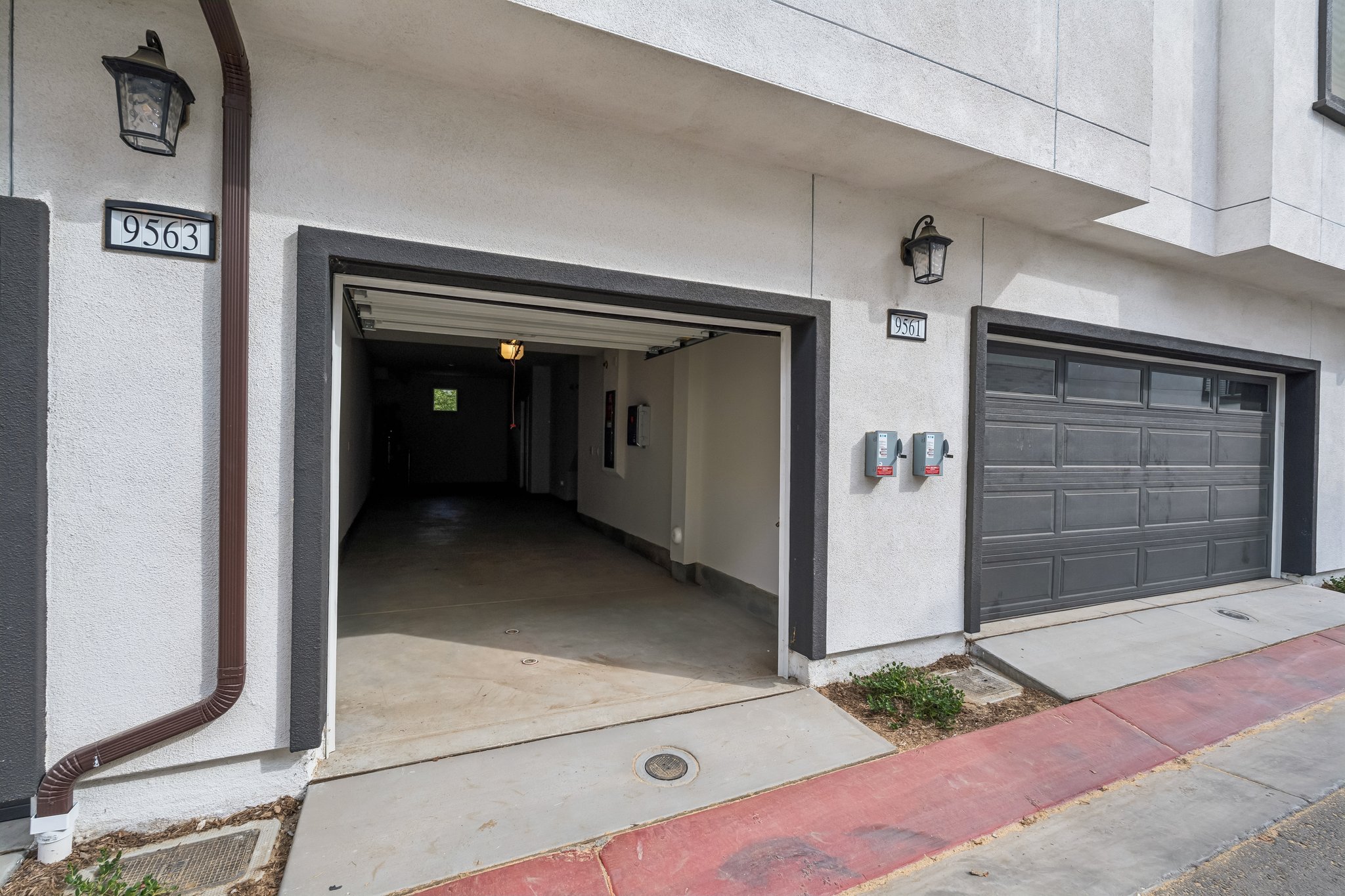 A garage with a door open.