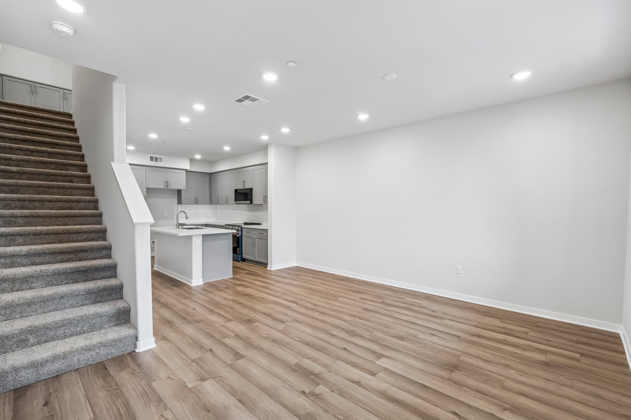 A kitchen with a wood floor.
