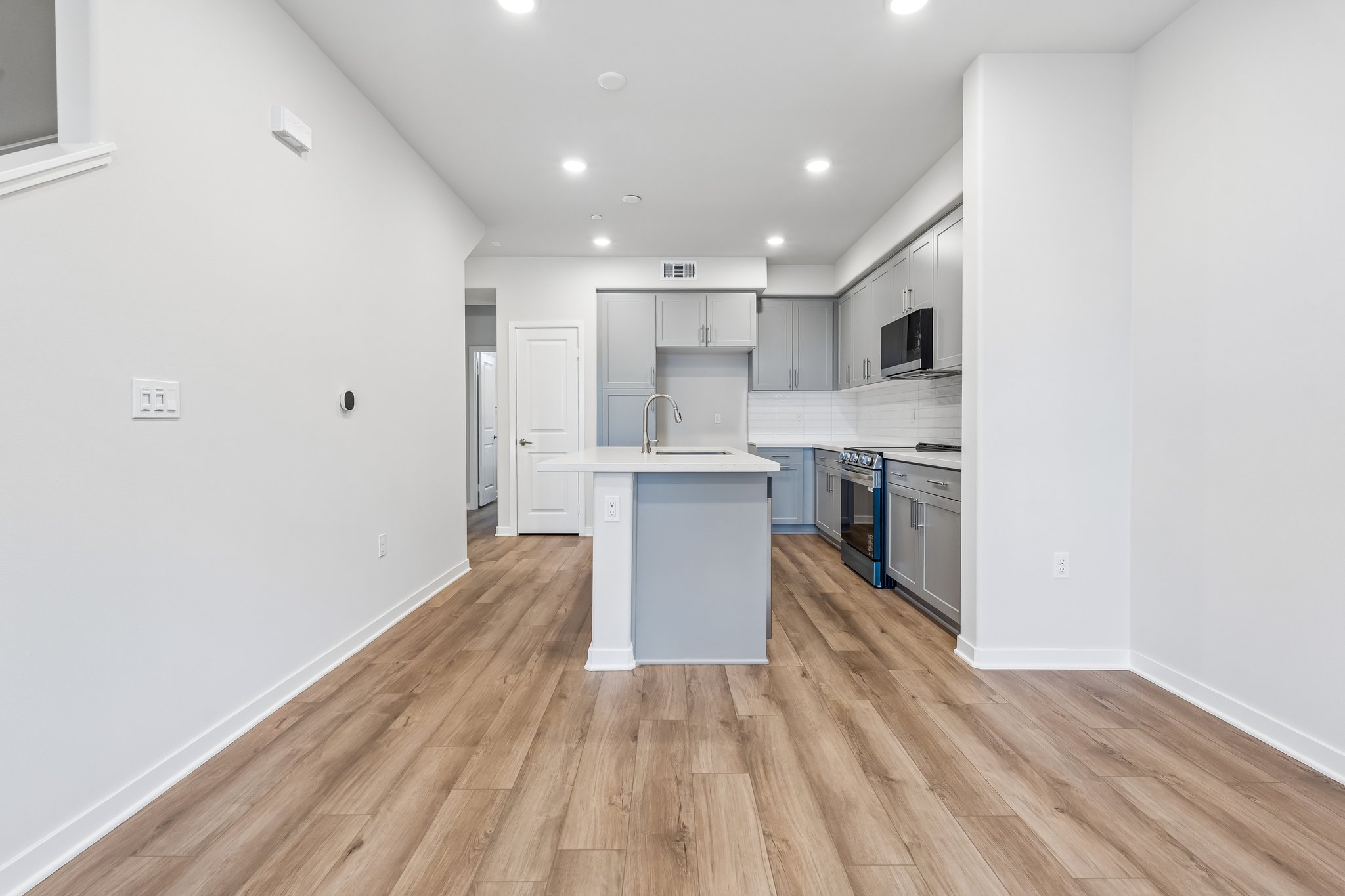 A kitchen with white cabinets.