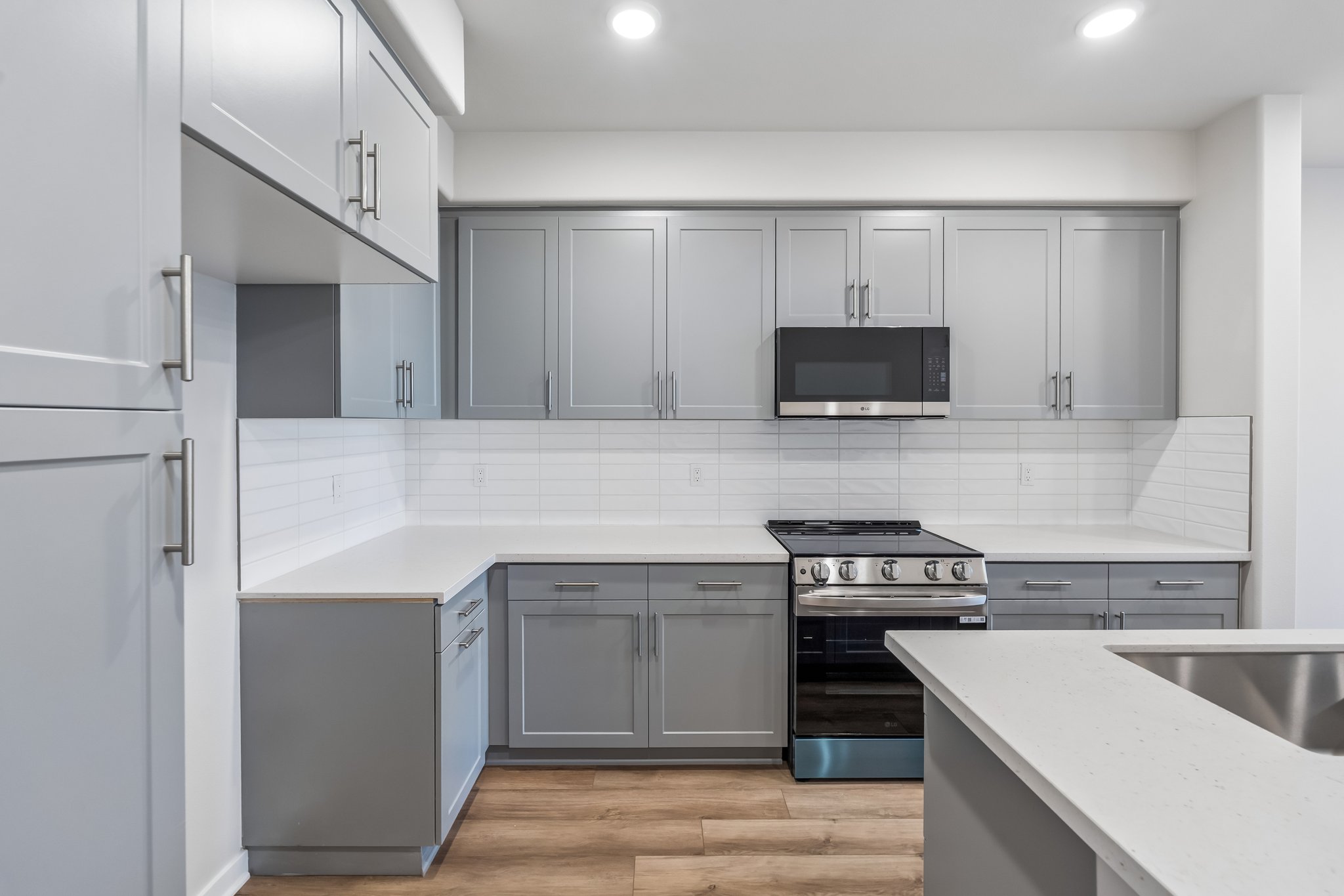 A kitchen with white cabinets.