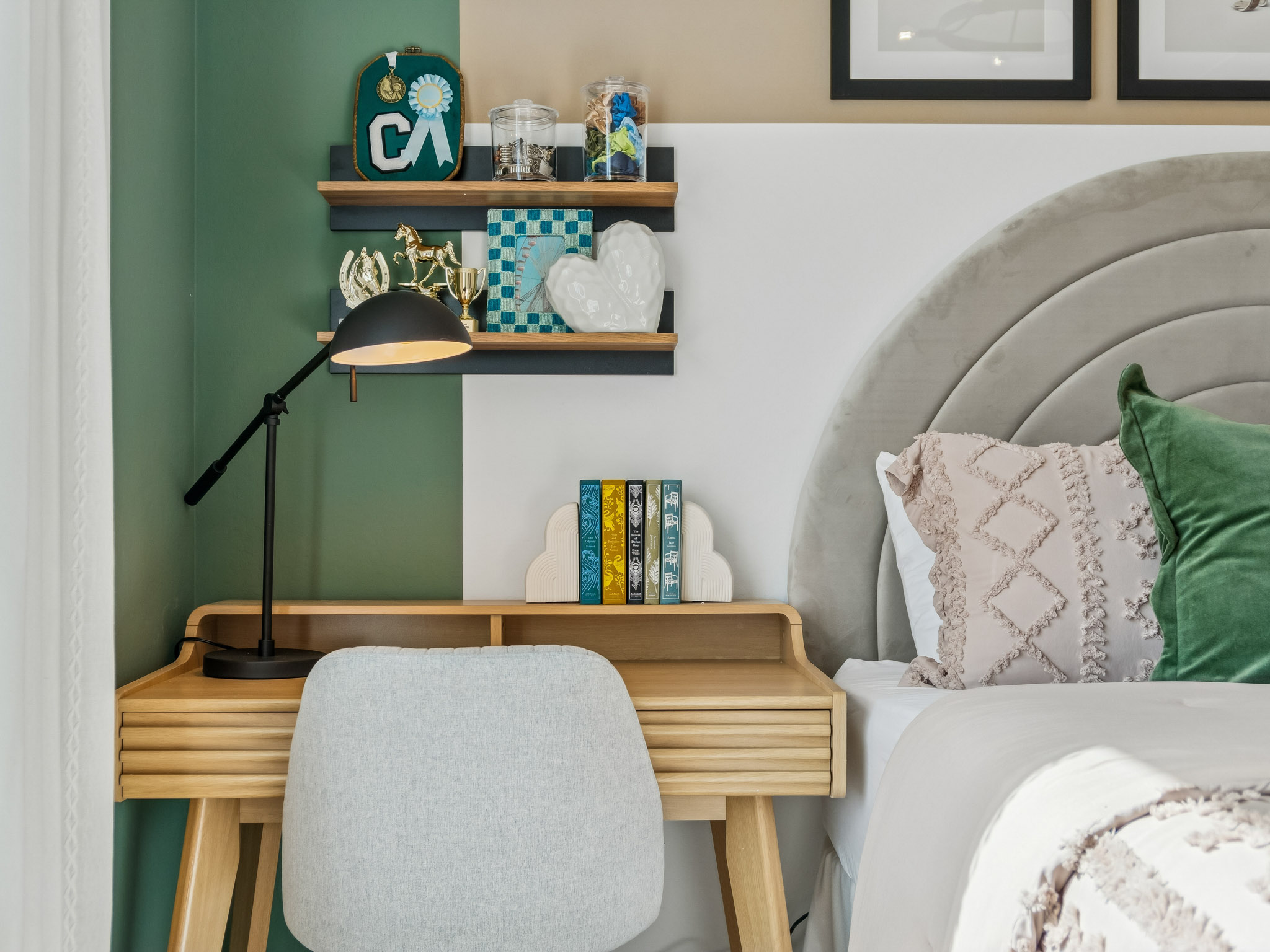A room with a shelf and a chair with a lamp and a shelf with objects on it.