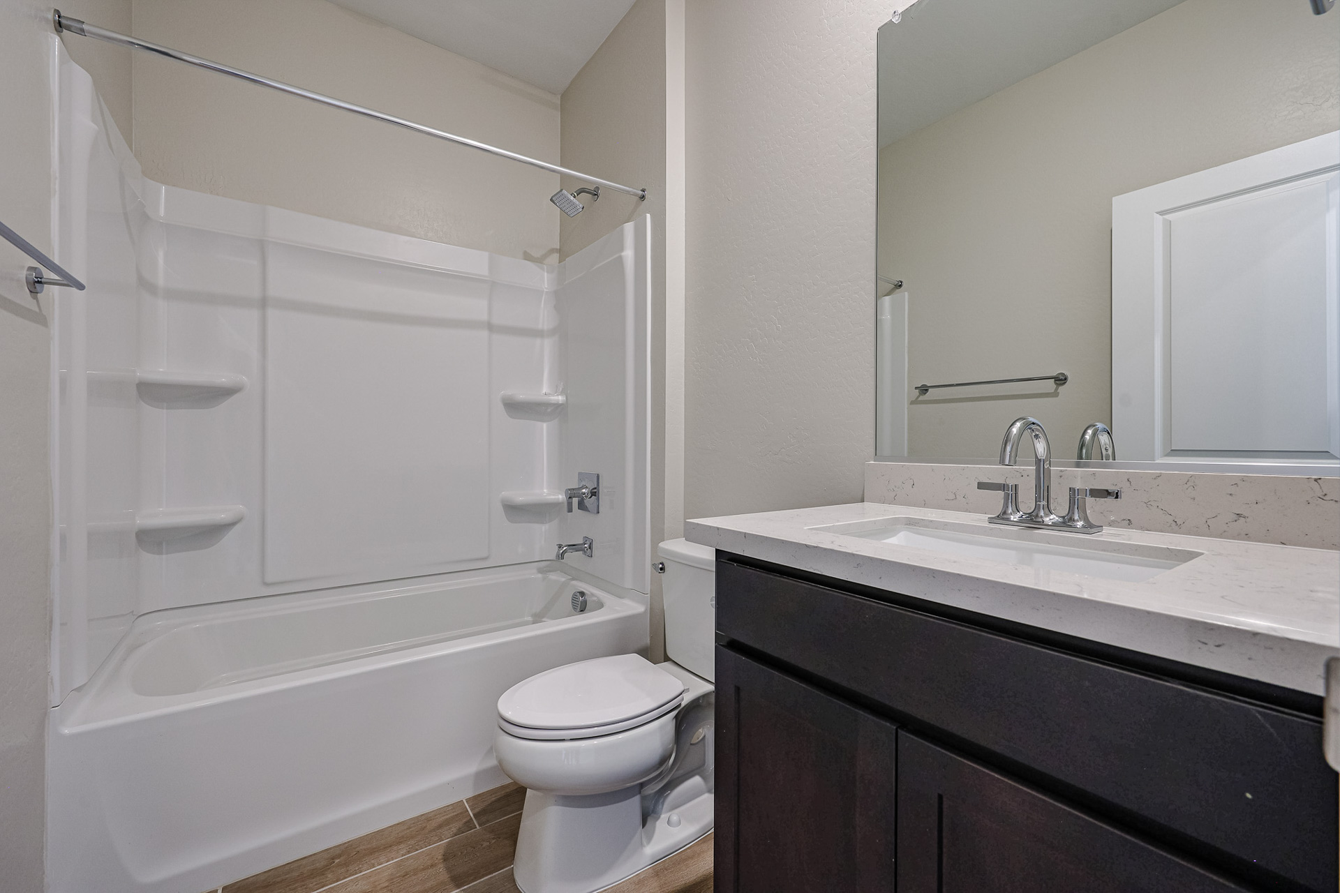 A bathroom with a tub sink and toilet.