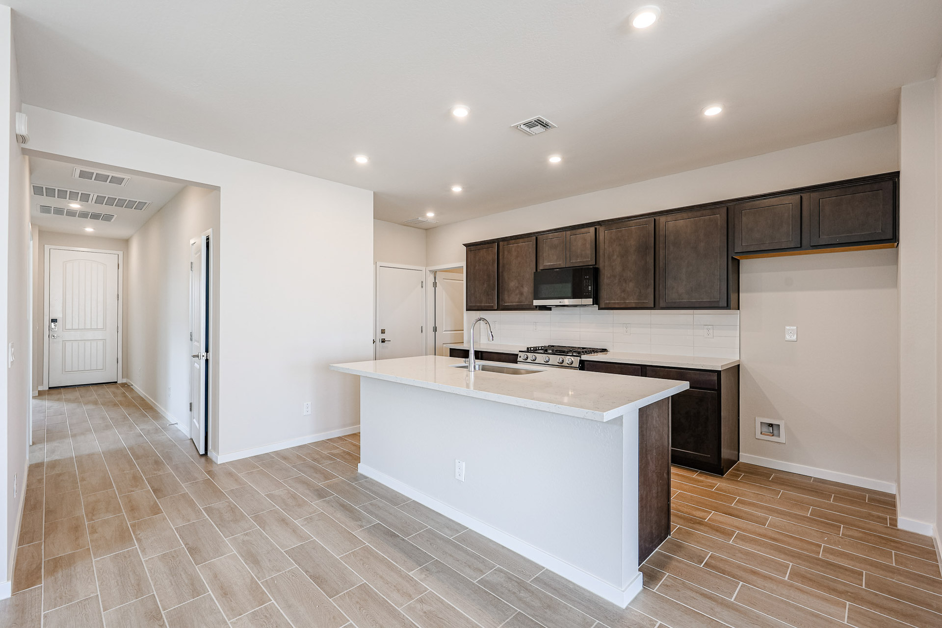 A kitchen with wooden cabinets.