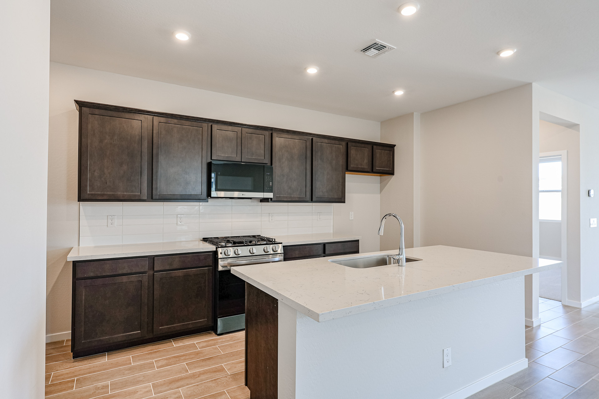 A kitchen with black cabinets.