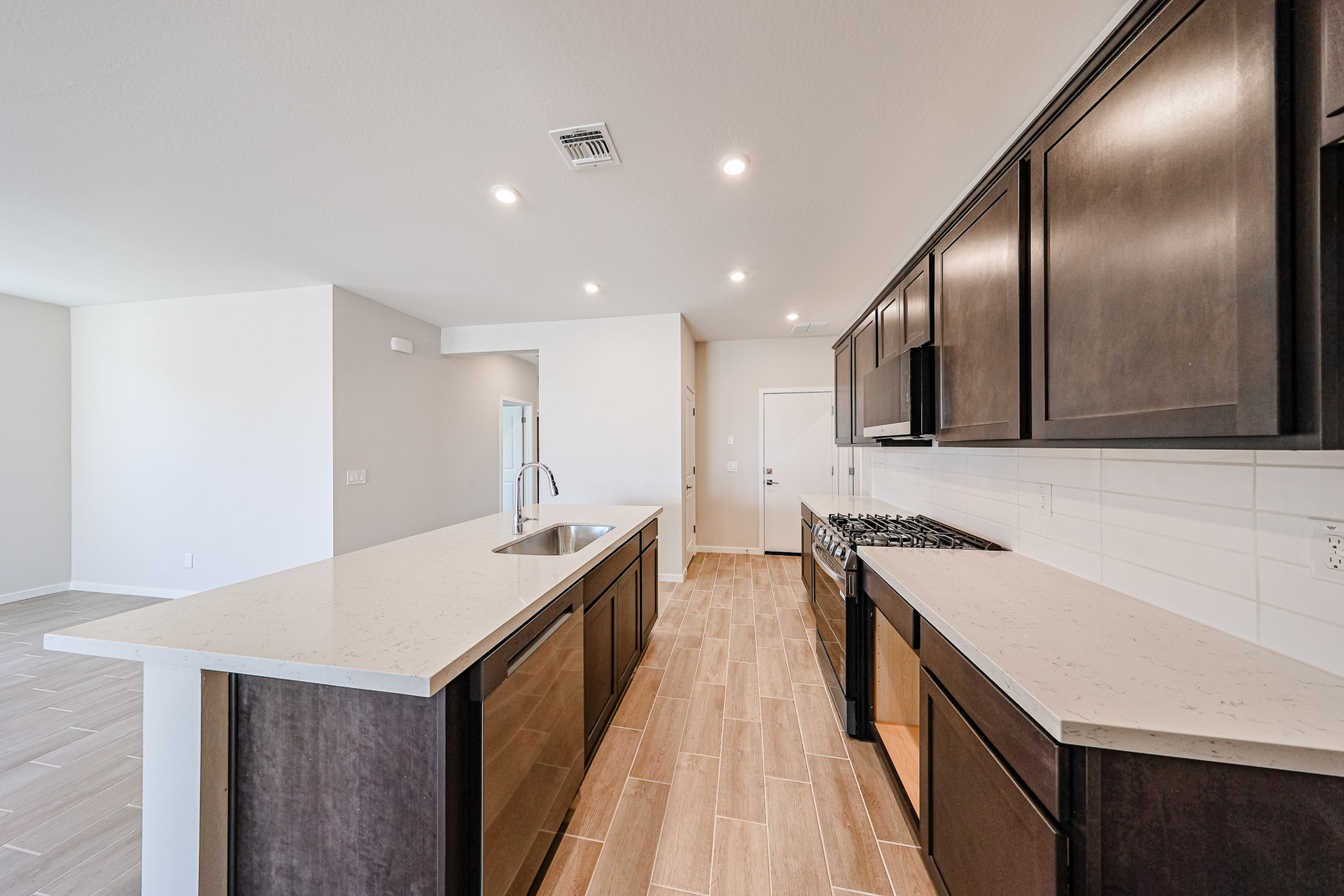 A kitchen with a wood floor.