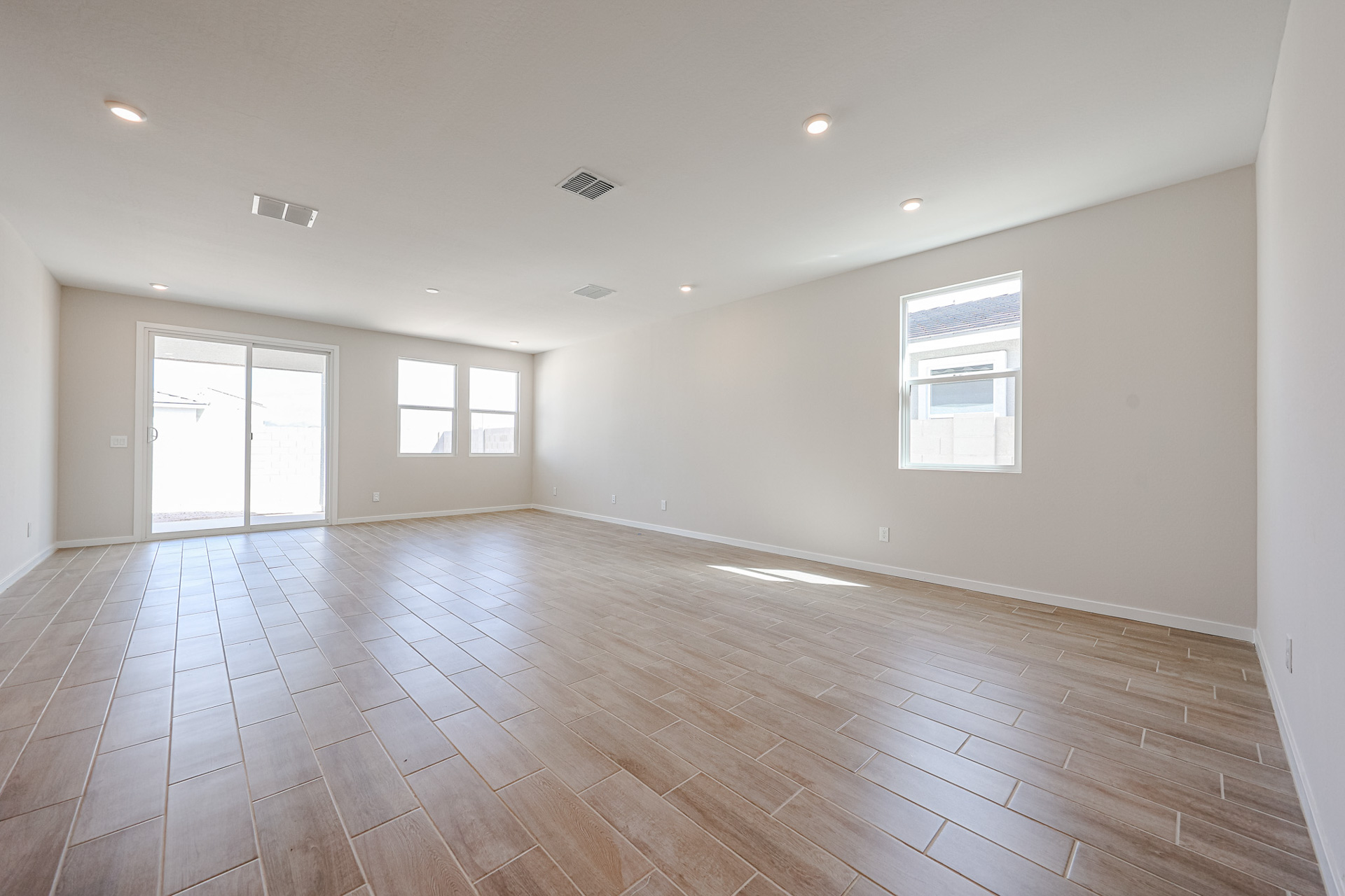 A room with a wood floor and windows.