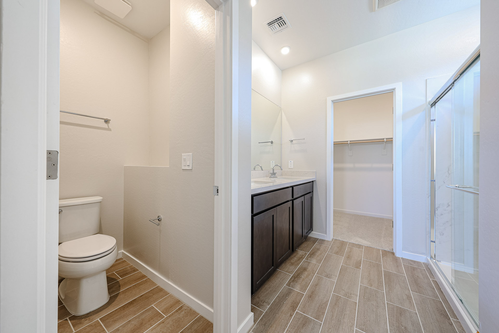 A bathroom with a toilet and shower.