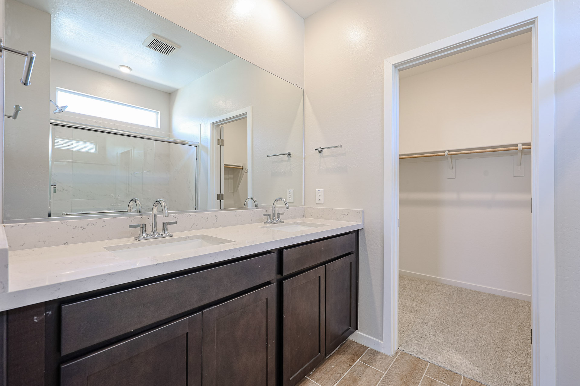A bathroom with a large mirror.