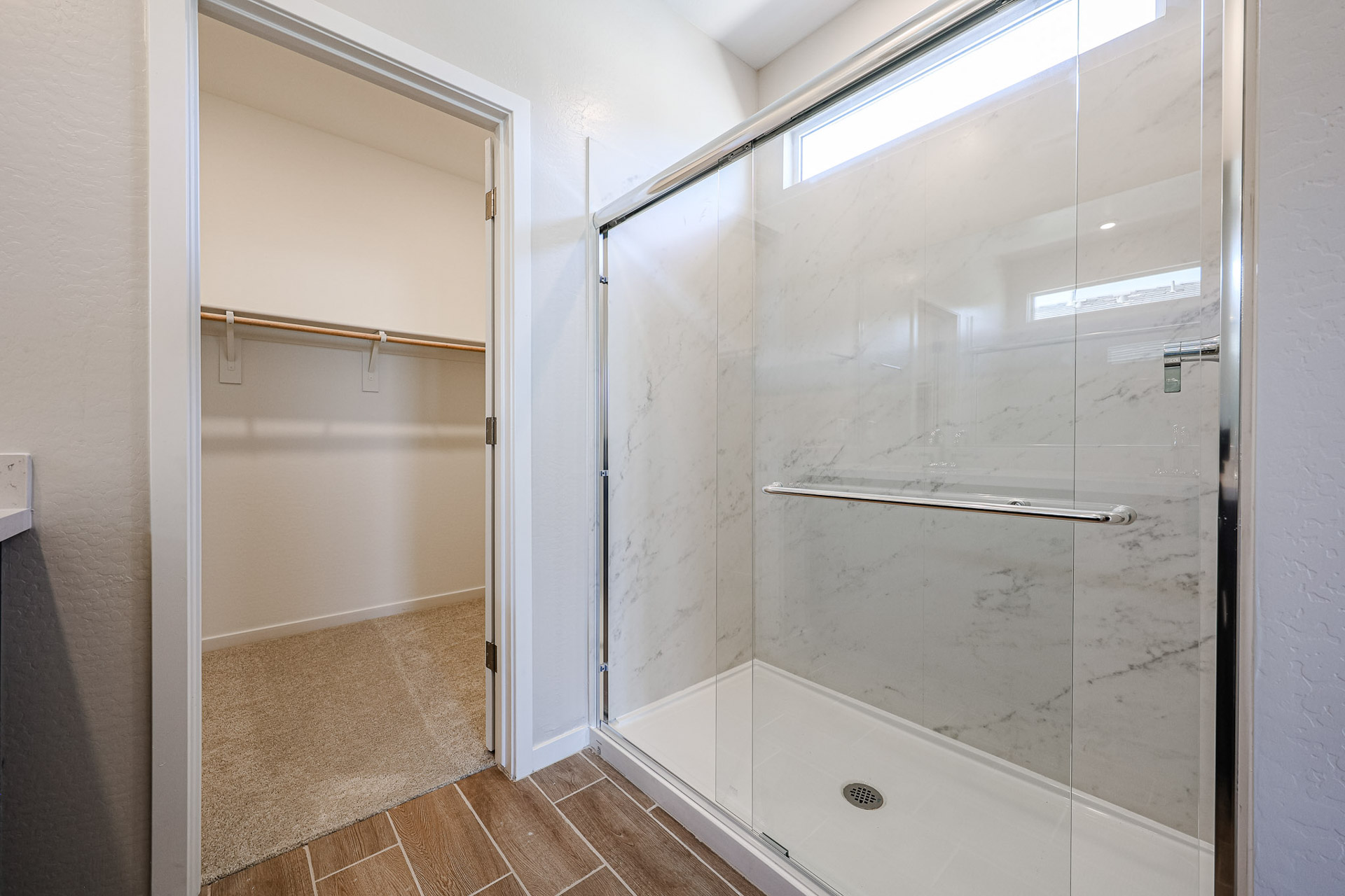 A shower with a glass door.