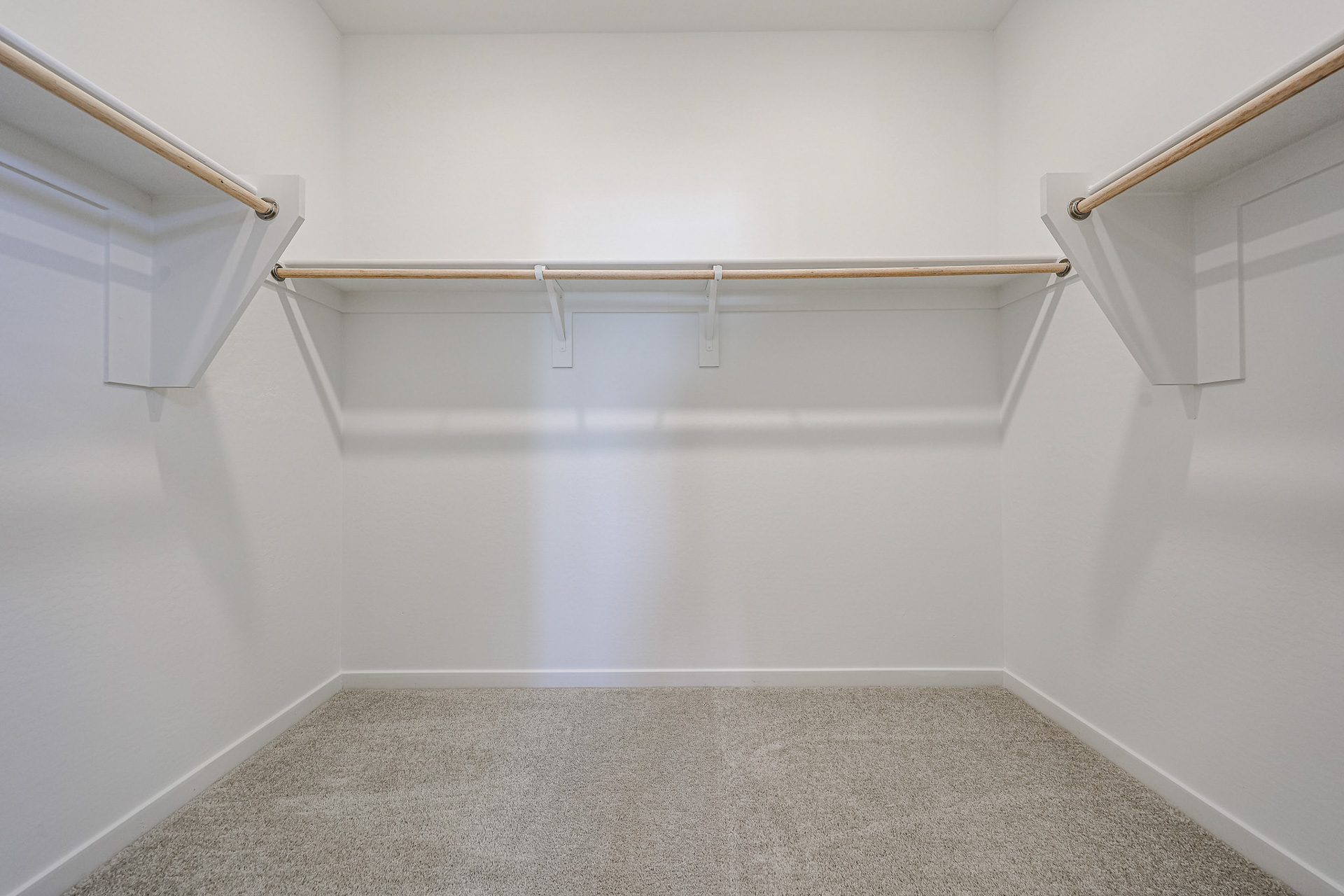 A white room with a few metal bars.