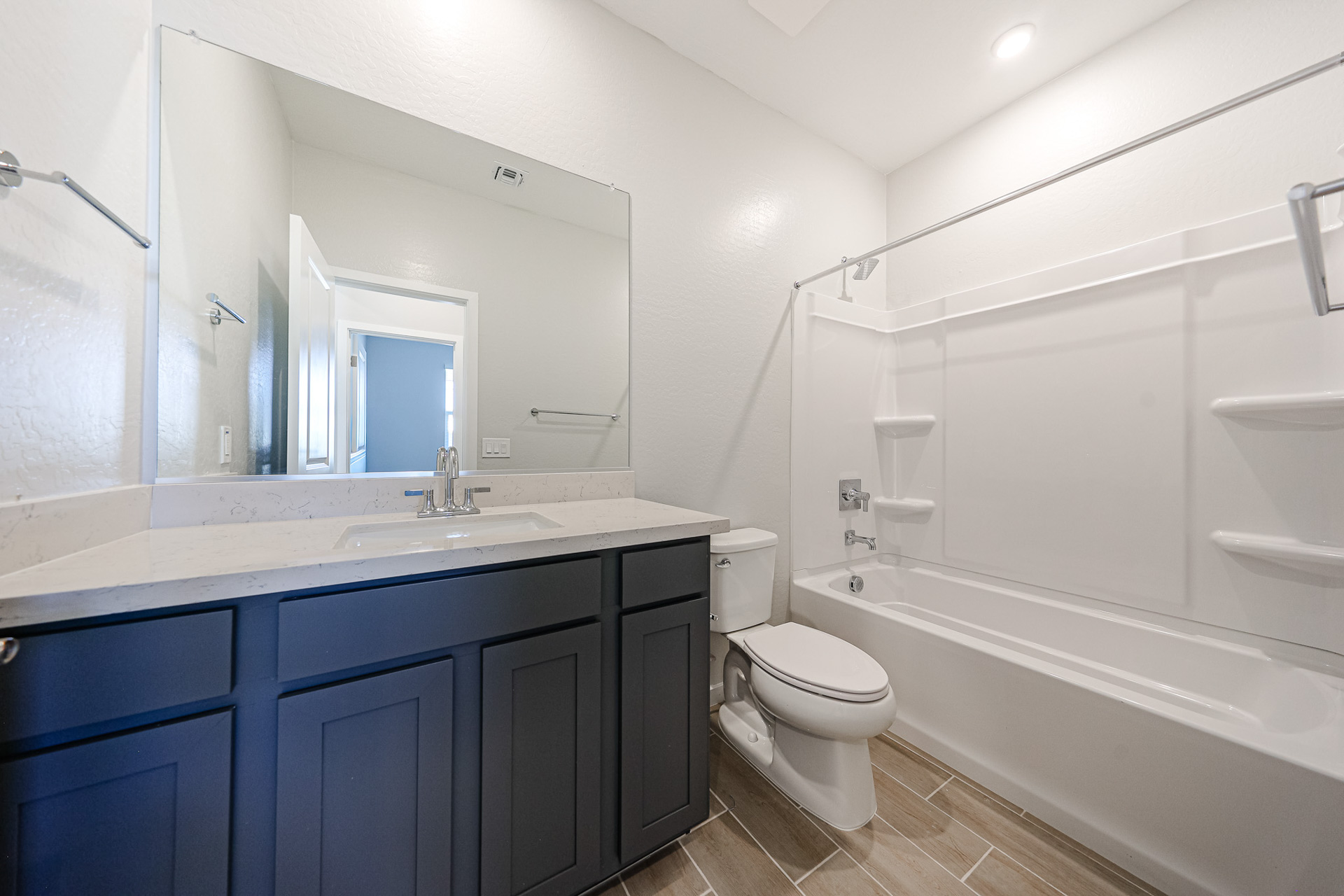 A bathroom with a tub sink and toilet.