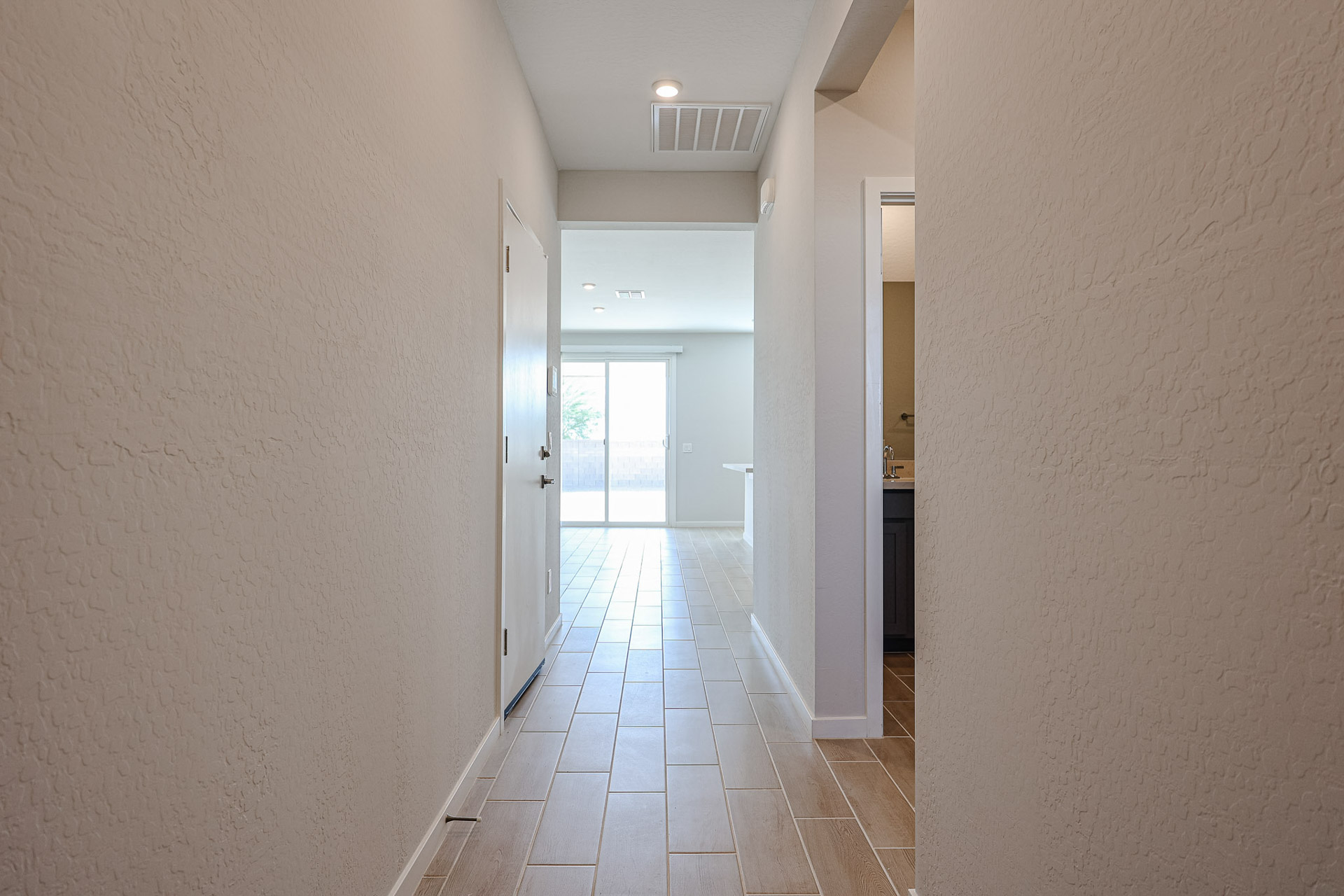 A hallway with white walls.