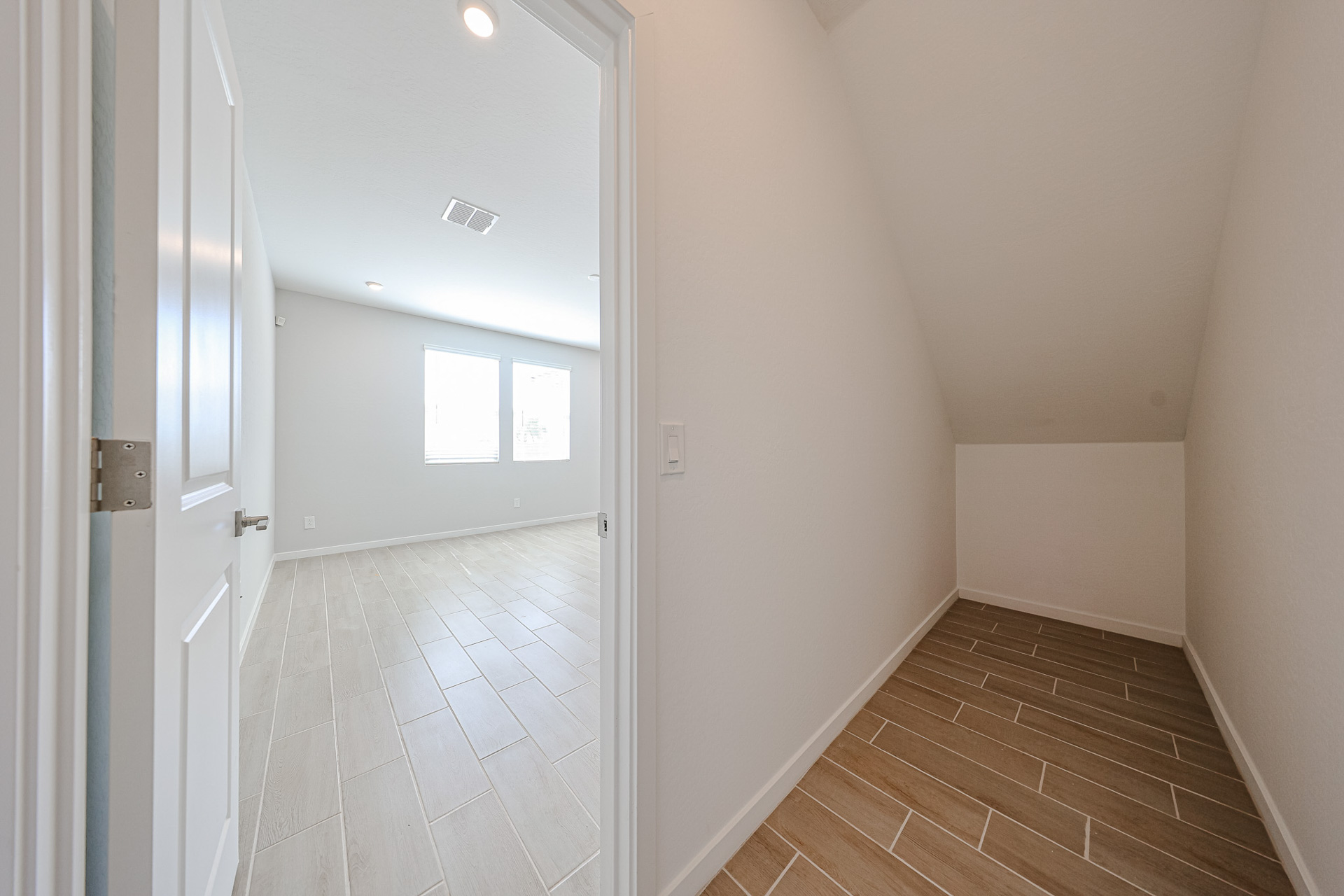 A hallway with white walls.