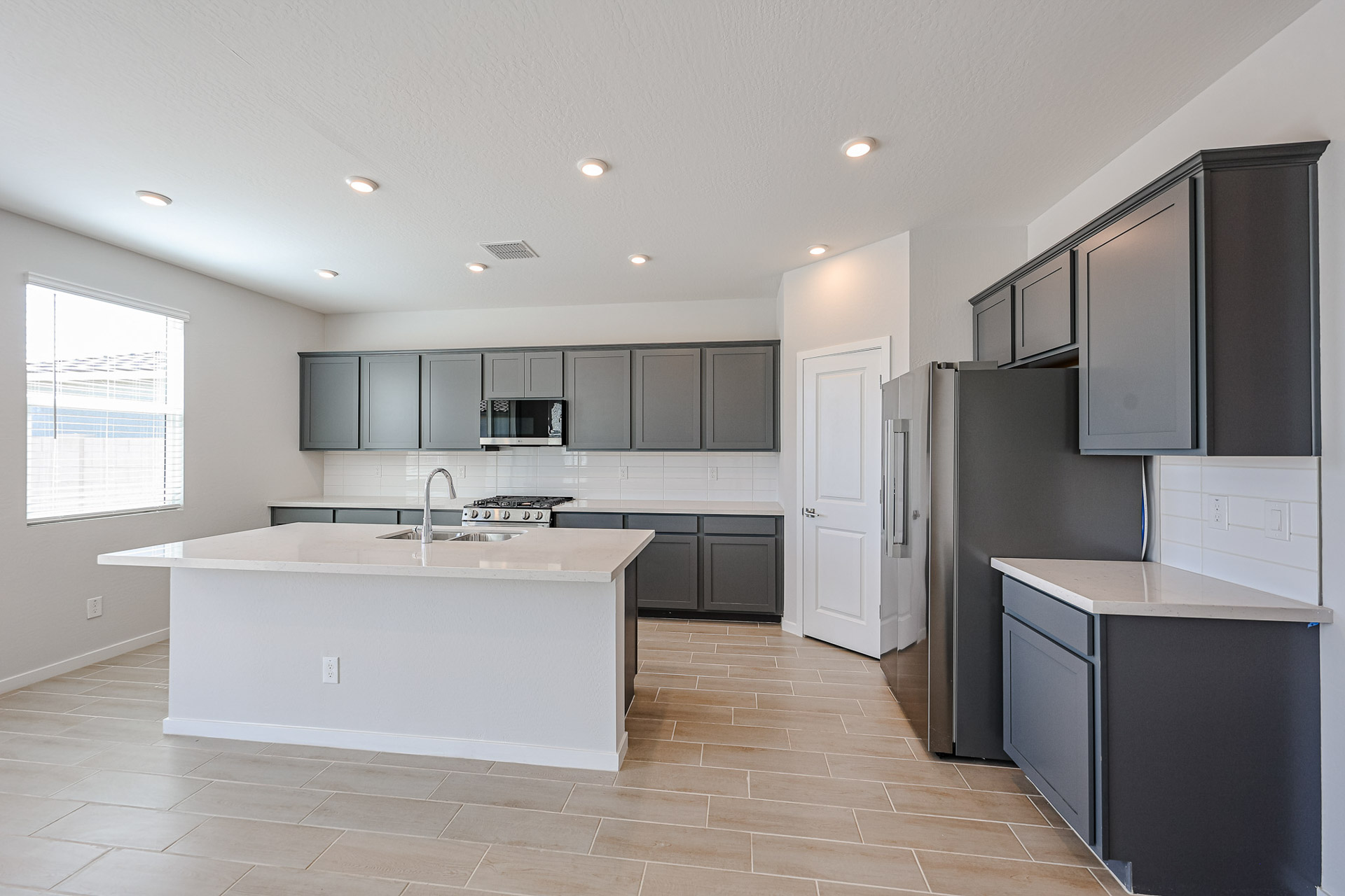 A kitchen with black cabinets.