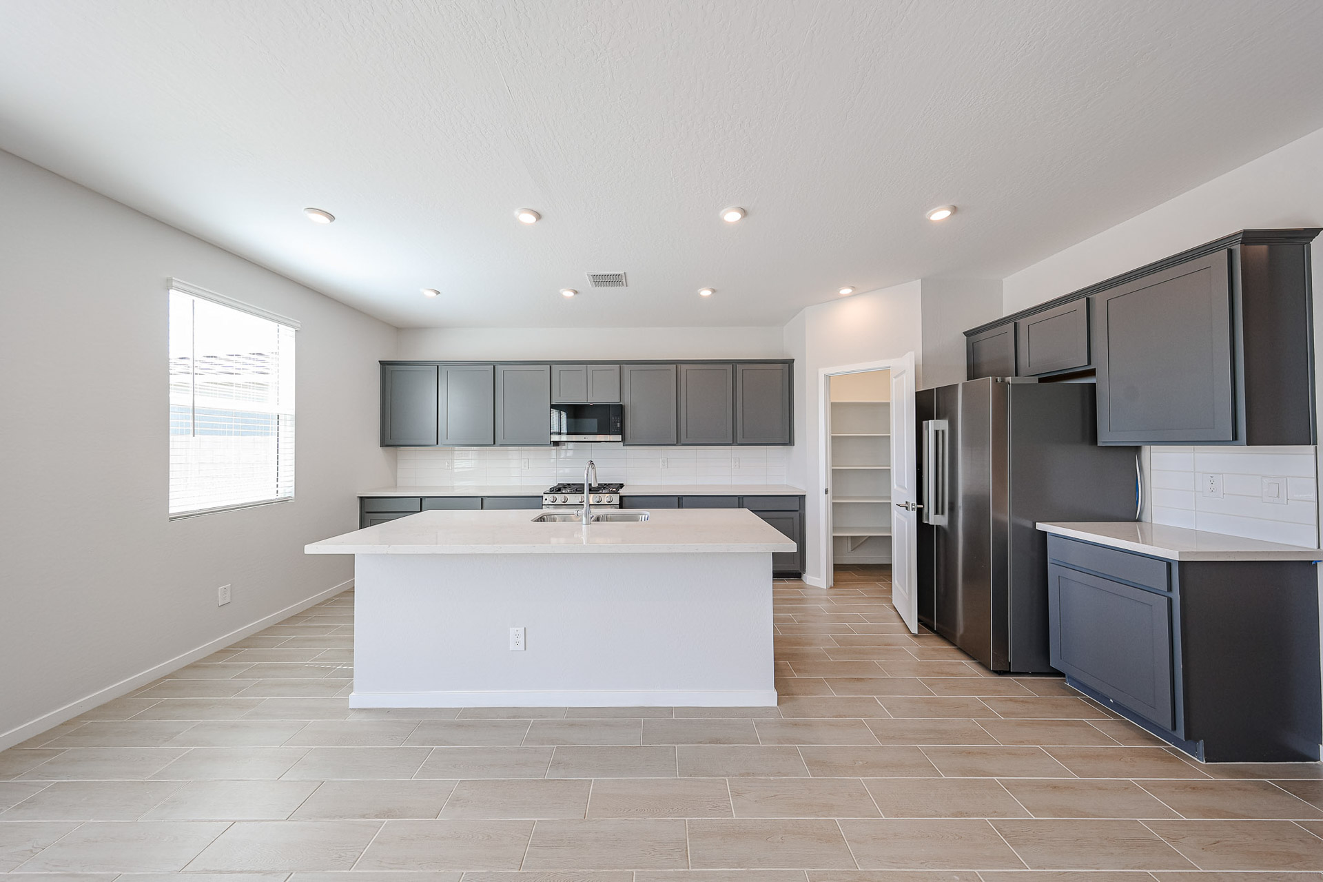 A kitchen with black cabinets.