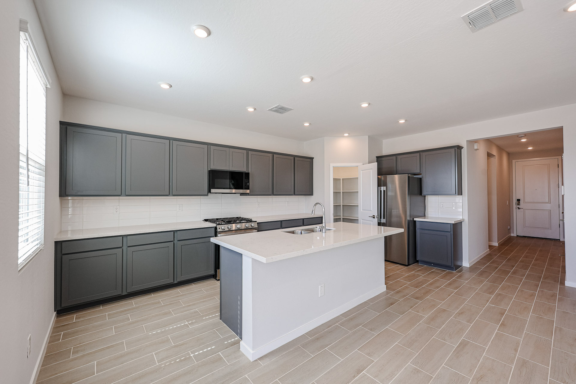 A kitchen with black cabinets.