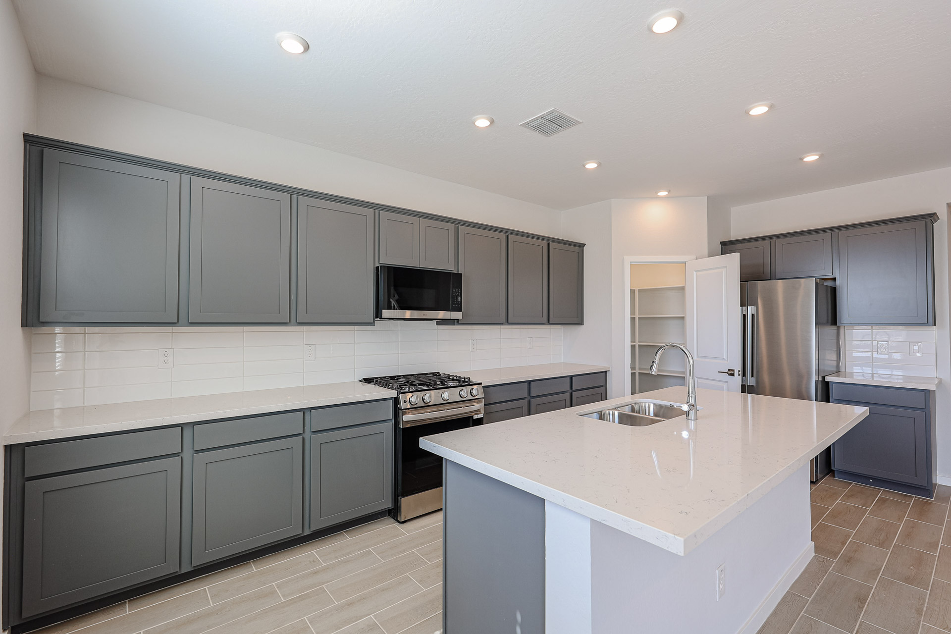 A kitchen with black cabinets.