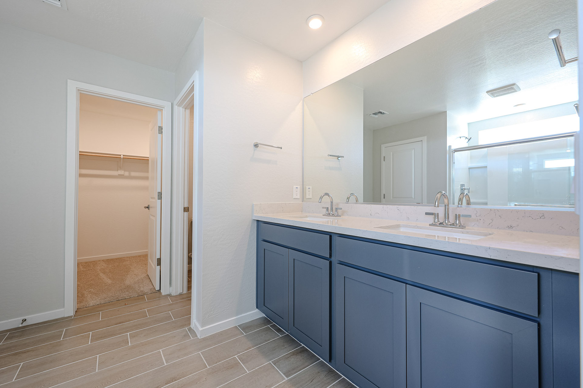 A bathroom with a large mirror.