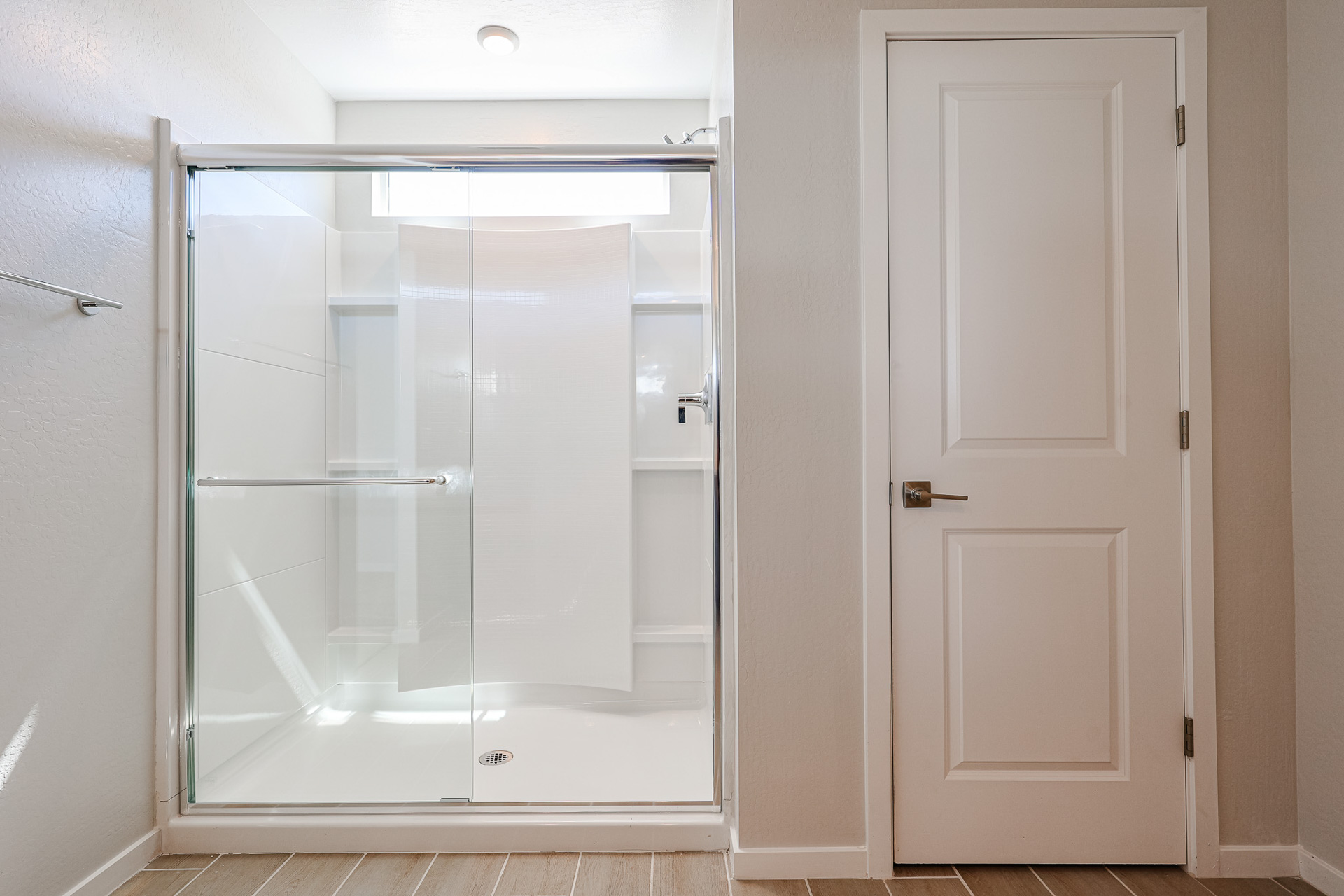 A shower with a glass door.