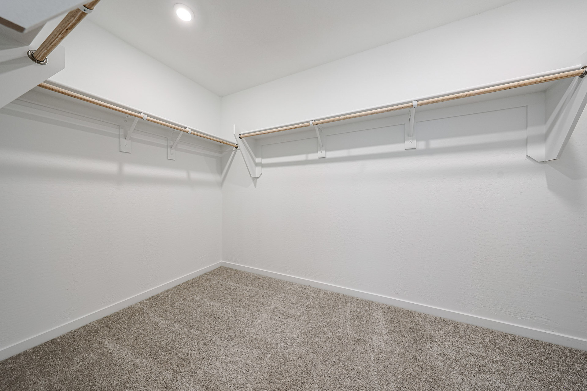 A white wall with a metal railing.